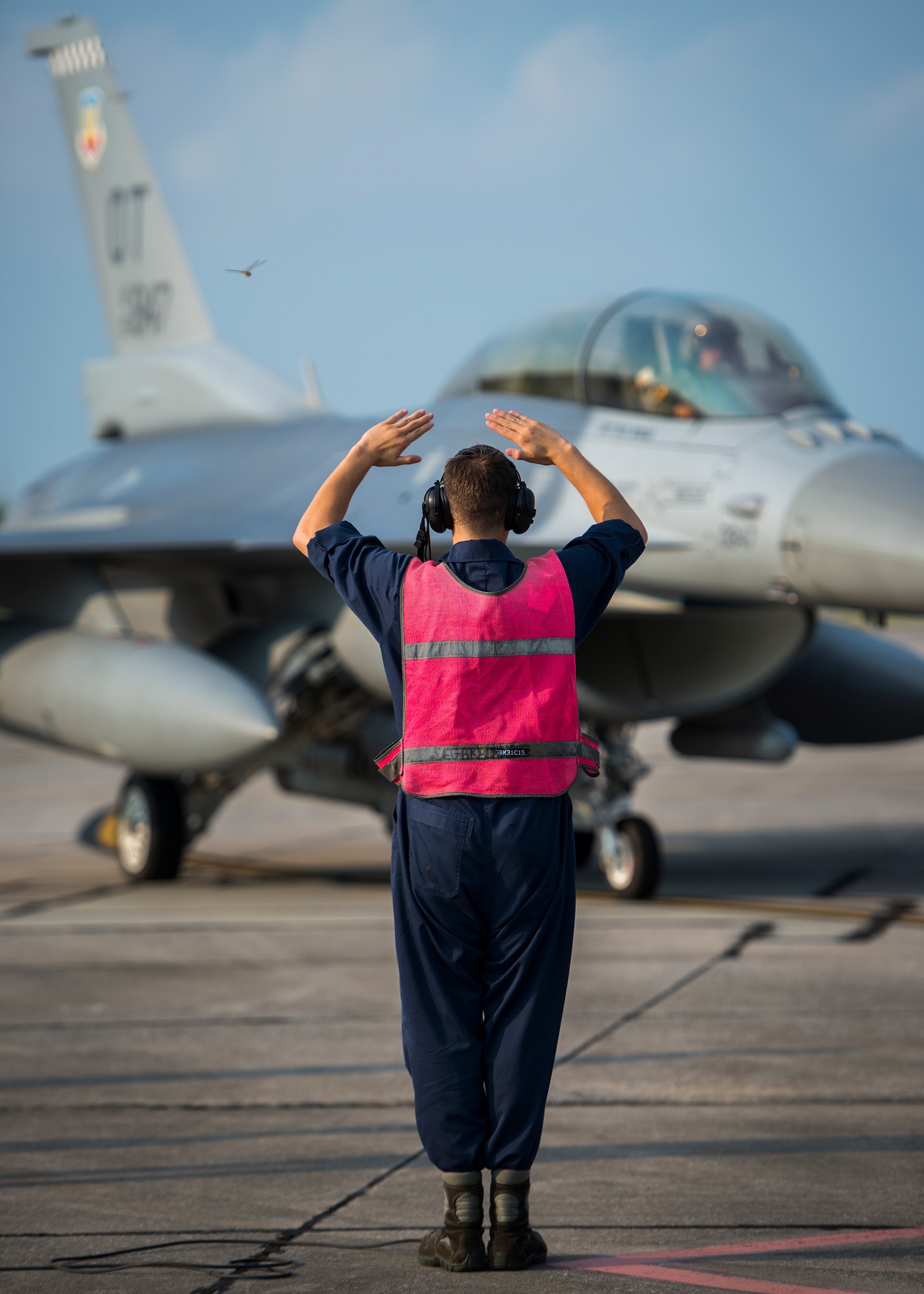 Airman 1st Class Clifford Bould, 96th Aircraft Maintenance Squadron, marshals in an F-16 Fighting Falcon for a final inspection from the end-of-runway crew at Eglin Air Force Base, Fla., Aug. 7.  The 96th Maintenance Group’s EOR crew is responsible for checking each aircraft for leaks, loose parts or any damage to the tires or aircraft before takeoffs and landings. (U.S. Air Force photo/Tech. Sgt. Jasmin Taylor)