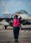 Airman 1st Class Clifford Bould, 96th Aircraft Maintenance Squadron, marshals in an F-16 Fighting Falcon for a final inspection from the end-of-runway crew at Eglin Air Force Base, Fla., Aug. 7.  The 96th Maintenance Group’s EOR crew is responsible for checking each aircraft for leaks, loose parts or any damage to the tires or aircraft before takeoffs and landings. (U.S. Air Force photo/Tech. Sgt. Jasmin Taylor)