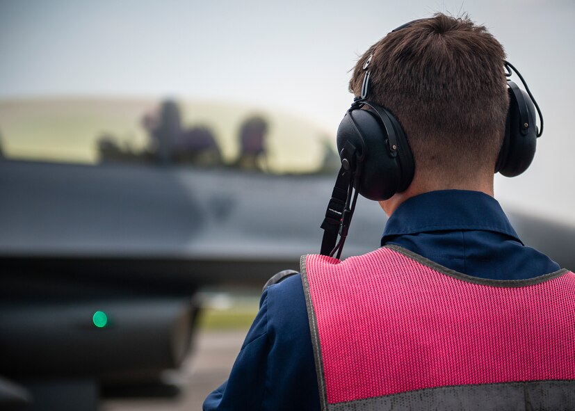 An end-of-runway Airman waits for the F-16 Fighting Falcon inspection to be complete before saluting the pilot at Eglin Air Force Base, Fla., Aug. 7.  The 96th Maintenance Group’s end-of-runway crew is the initial and final set of eyes to examine 53rd Wing and 96th Test Wing aircraft before takeoff and upon arrival. (U.S. Air Force photo/Tech. Sgt. Jasmin Taylor)