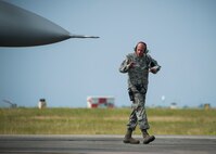 Tech. Sgt. Arthur Hamblin, 96th Aircraft Maintenance Squadron, signals to a pilot during routine inspection at Eglin Air Force Base, Fla., Aug. 7.  The 96th Maintenance Group’s EOR crew is responsible for checking each aircraft for leaks, loose parts or any damage to the tires or aircraft before takeoffs and landings. (U.S. Air Force photo/Tech. Sgt. Jasmin Taylor)