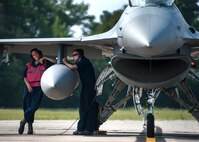 Maintainers from the 96th Aircraft Maintenance Squadron find some shade from the heat of the day underneath the wing of an F-16 Fighting Falcon prior to inspecting it for takeoff at Eglin Air Force Base, Fla., Aug. 7.  The 96th Maintenance Group’s end-of-runway crew is the initial and final set of eyes to examine 53rd Wing and 96th Test Wing aircraft before takeoff and upon arrival. (U.S. Air Force photo/Tech. Sgt. Jasmin Taylor)