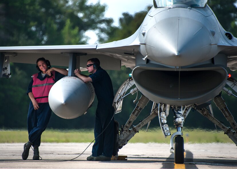 Maintainers from the 96th Aircraft Maintenance Squadron find some shade from the heat of the day underneath the wing of an F-16 Fighting Falcon prior to inspecting it for takeoff at Eglin Air Force Base, Fla., Aug. 7.  The 96th Maintenance Group’s end-of-runway crew is the initial and final set of eyes to examine 53rd Wing and 96th Test Wing aircraft before takeoff and upon arrival. (U.S. Air Force photo/Tech. Sgt. Jasmin Taylor)