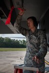 Senior Airman Andrew Jensen, 96th Aircraft Maintenance Squadron, pulls the chaff flare pin at Eglin Air Force Base, Fla., Aug. 7.  The 96th Maintenance Group’s end-of-runway weapons crew is responsible for removing the safety pins from the jet’s munitions prior to take off and replacing them upon arrival. (U.S. Air Force photo/Tech. Sgt. Jasmin Taylor)