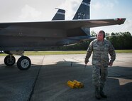 Staff Sgt. Michael Hilborn, 96th Aircraft Maintenance Squadron, removes the chocks after an inspection at Eglin Air Force Base, Fla., Aug. 7.  The 96th Maintenance Group’s end-of-runway weapons crew is responsible for removing the safety pins from the jet’s munitions prior to take off and replacing them upon arrival. (U.S. Air Force photo/Tech. Sgt. Jasmin Taylor)