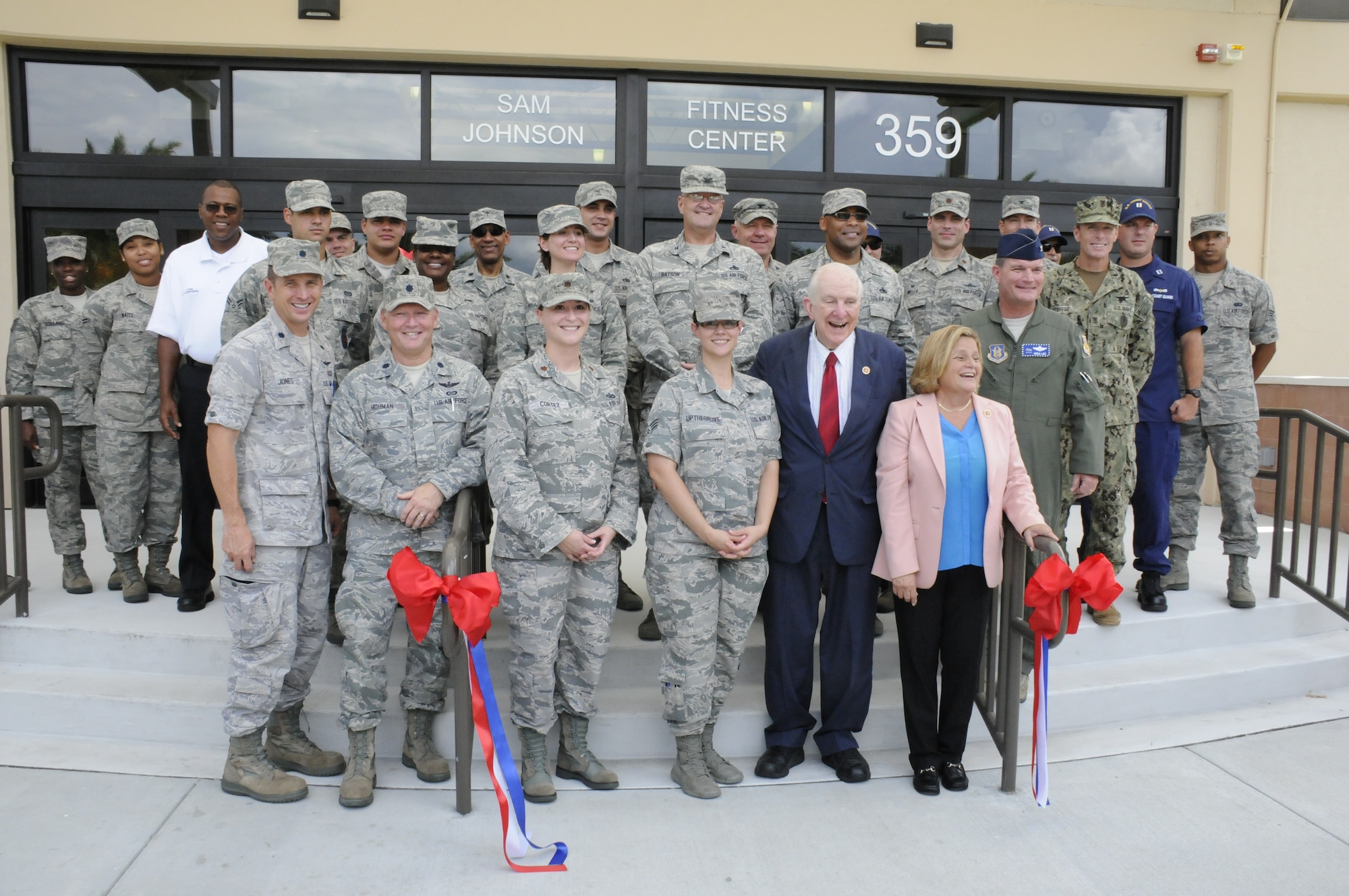 Members from Homestead Air Reserve Base gather together around the newly renovated Sam Johnson Fitness Center. Congressman Sam Johnson, representing the 3rd District of Texas, came to the base for the ribbon cutting of the fitness center, which is named after the congressman Aug. 20. Congresswoman Ileana Ros-Lehtinen, representing Florida’s 27th Congressional District, also attended the ribbon cutting events. (Air Force photo/Senior Airman Nicolas Caceres)