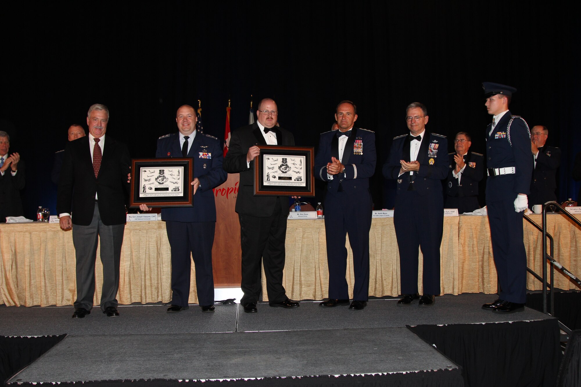 Among awards given the final night of Civil Air Patrol’s 2014 National Conference August 14-16 in Las Vegas, was the Air Forces Northern Commander’s Meritorious Service Award for the most outstanding CAP support of an event. This year, the award recognized the combined efforts of the North Carolina CAP wing and South Carolina CAP wing. Together, they were recognized for their exemplary support of a U.S.  Marine Corps Unmanned Aerial System Airspace Integration Exercise at Marine Corps Air Station Cherry Point, N.C. during in August, 2013. (From left are) Maj. Steven Askew, CAP pilot, South Carolina Wing, who flew as part of the awarded mission; Col Frances Smith Jr., South Carolina Wing Commander; Col. Dave Crawford, North Carolina Wing Commander; Maj. Gen. Trulan Eyre, Air National Guard Assistant to the Commander, Continental U.S. Northern Aerospace Defense Region-1st Air Force (AFNORTH); and Maj. Gen. Joseph Vazquez, new Civil Air Patrol National Commander. (Photo by Susan Schneider/CAP National Headquarters)

