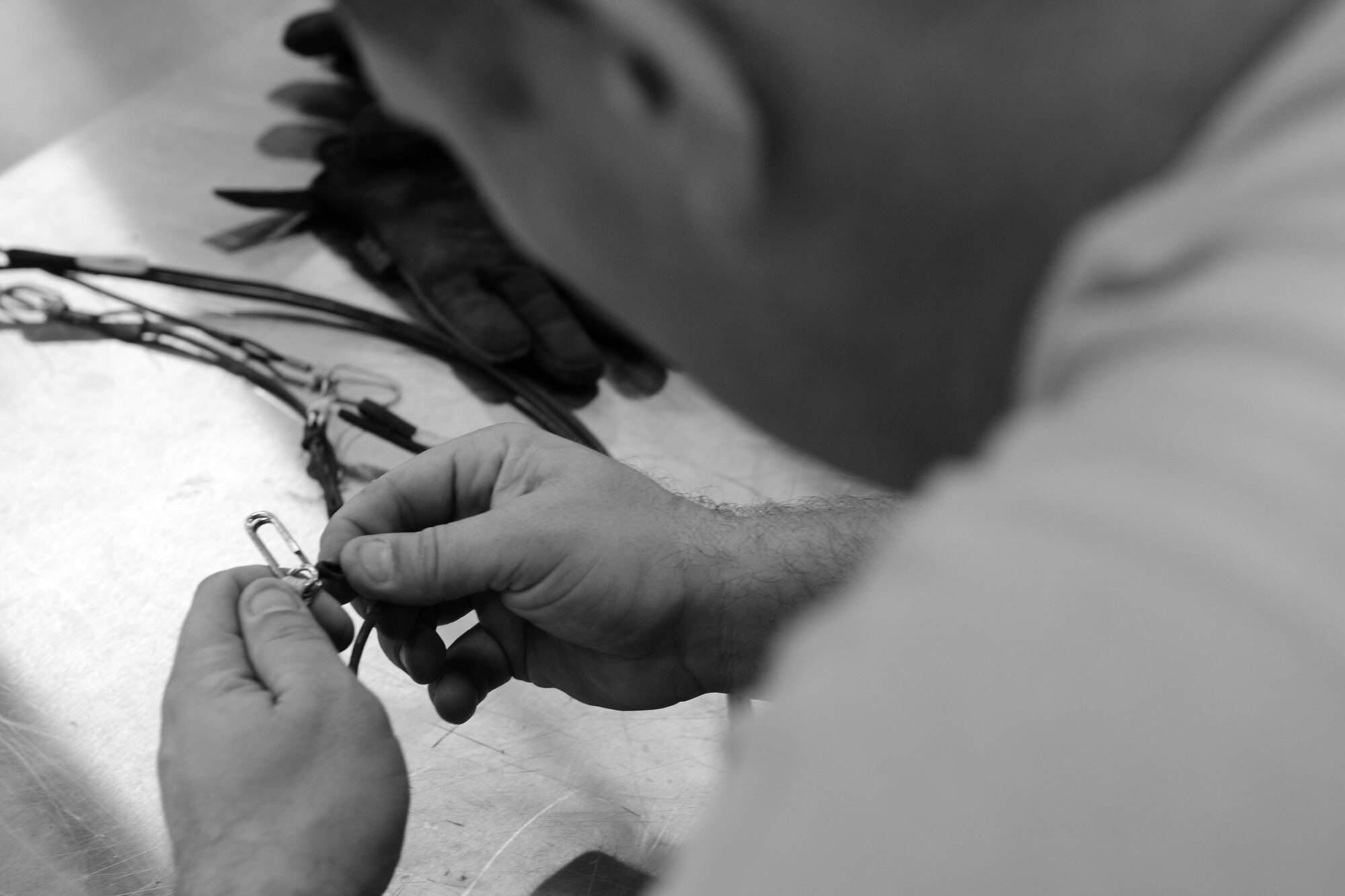 U.S. Air Force Tech. Sgt. Wesley Cummins, 379th Expeditionary Maintenance Squadron conventional maintenance supervisor, puts together a foreign object damage-free kit at Al Udeid Air Base, Qatar, Aug. 20, 2014. The kit, part of a lanyard, creates and extension from an aircraft to a guided bomb unit. Cummins is deployed from Dyess Air Force Base, Texas and hails from Belton, Texas. (U.S. Air Force photo by Staff Sgt. Ciara Wymbs)