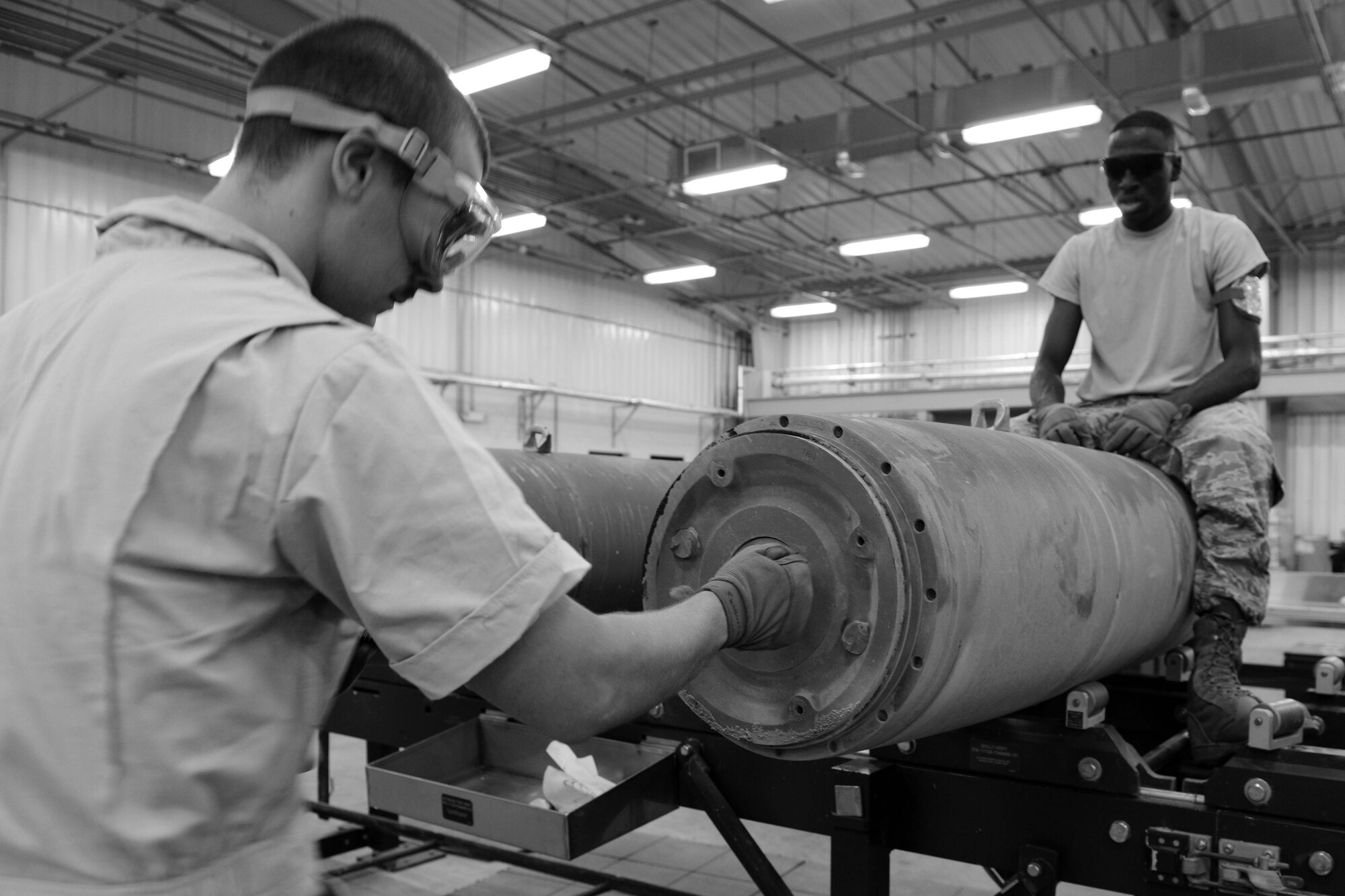 U.S. Air Force Airmen 1st Class Joseph Williams and Carvell McCullough, 379th Expeditionary Maintenance Squadron conventional maintenance crewmembers load a fuse into a guided bomb unit at Al Udeid Air Base, Qatar, Aug. 20, 2014. A GBU is a precision-guided munition designed to achieve greater accuracy. Both Airmen are deployed from Dyess Air Force Base, Texas. Williams hails from Houston and McCullough is from Oklahoma City. (U.S. Air Force photo by Staff Sgt. Ciara Wymbs)