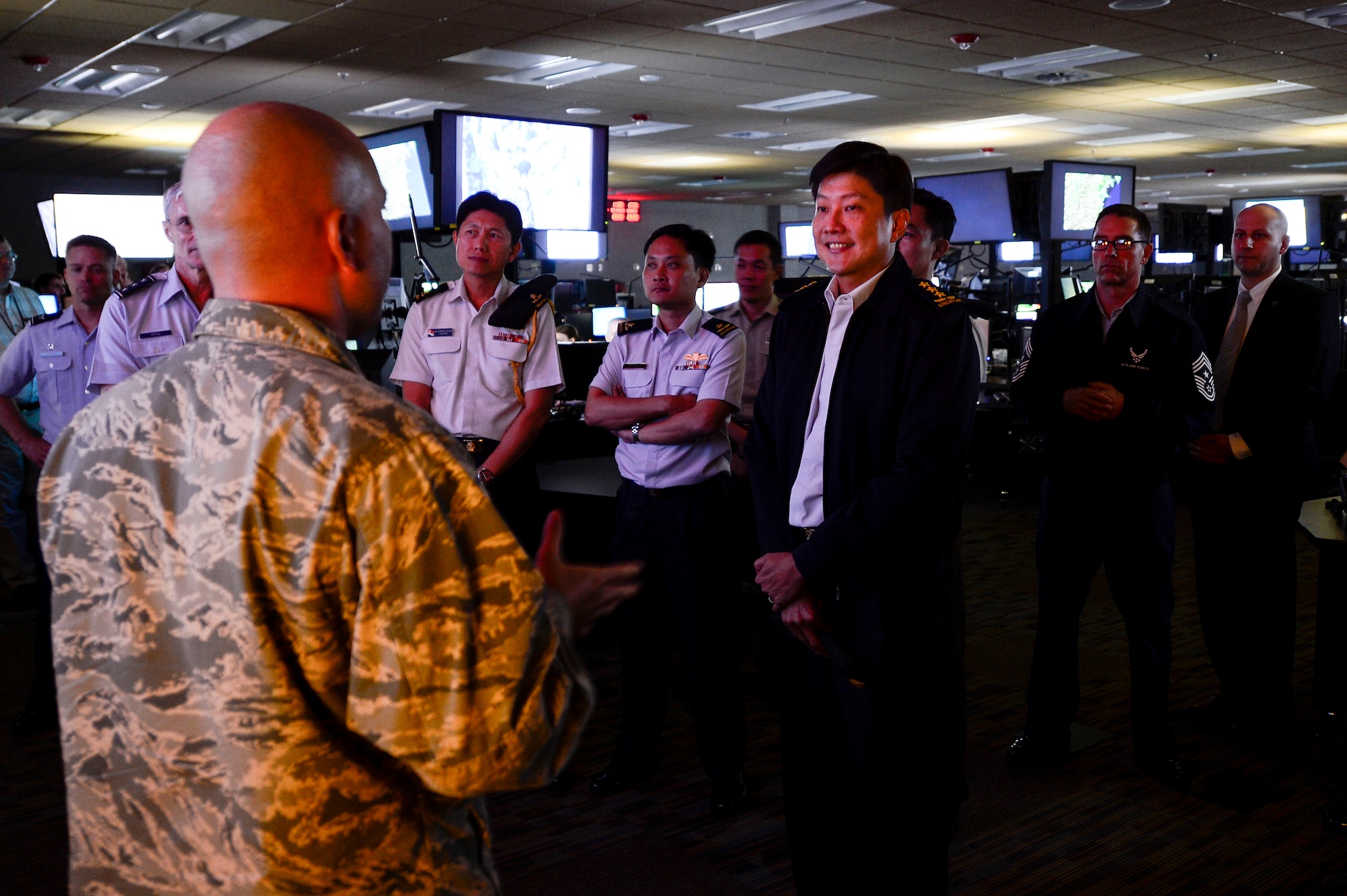 Republic of Singapore Air Force Lt. Gen. Ng Chee Meng, Chief of Defense Force, receives a briefing during a tour of the 480th Intelligence Surveillance Reconnaissance Wing at Langley Air Force Base, Va., Aug. 20, 2014. The tour provided agencies at Joint Base Langley-Eustis, Va., an opportunity to strengthen bonds between the U.S. military and Singapore. (U.S. Air Force photo by Senior Airman Kayla Newman/Released)