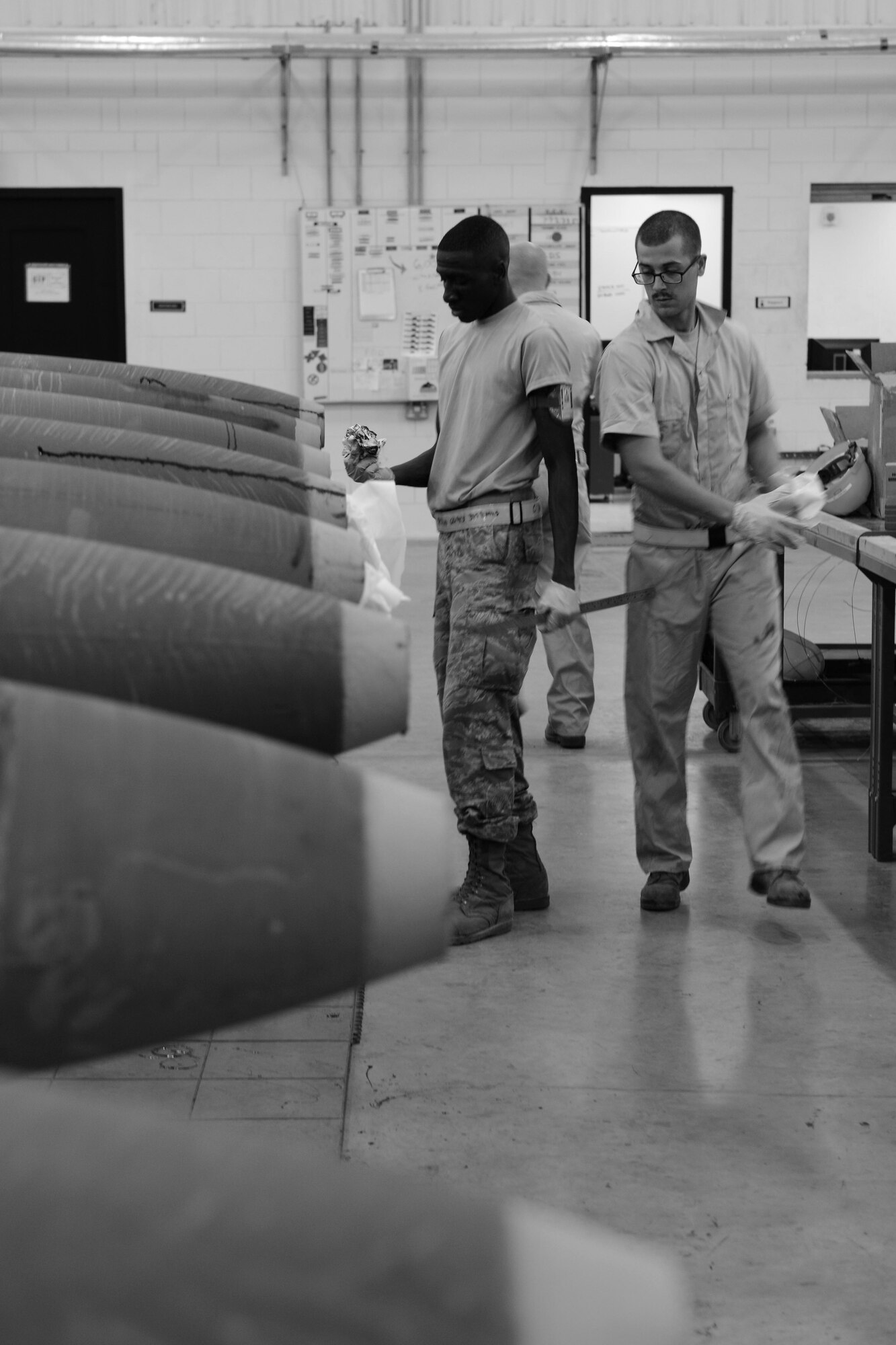 U.S. Air Force Airmen 1st Class Carvell McCullough and Joseph Williams, 379th Expeditionary Maintenance Squadron conventional maintenance crewmembers prepare to build a guided bomb unit at Al Udeid Air Base, Qatar, Aug. 20, 2014. The Airmen are part of a new rotation at AUAB, and on average they build approximately 60 bombs monthly. (U.S. Air Force photo by Staff Sgt. Ciara Wymbs)