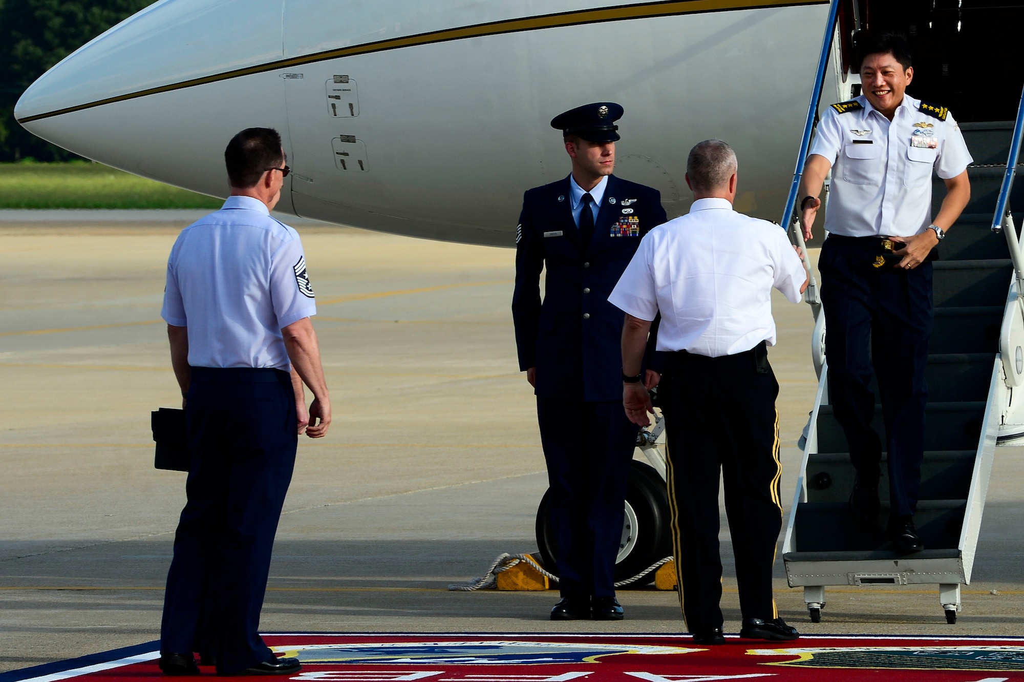 Republic of Singapore Air Force Lt. Gen. Ng Chee Meng, Chief of Defense Force, is greeted by U.S. Army Lt. Gen. Kevin Mangum, Training and Doctrine Command chief of staff, at Langley Air Force Base, Va., Aug. 20, 2014. During his visit, NG toured the Training Brain Operations Center and the 480th Intelligence Surveillance Reconnaissance Wing. (U.S. Air Force photo by Senior Airman Kayla Newman/Released) 