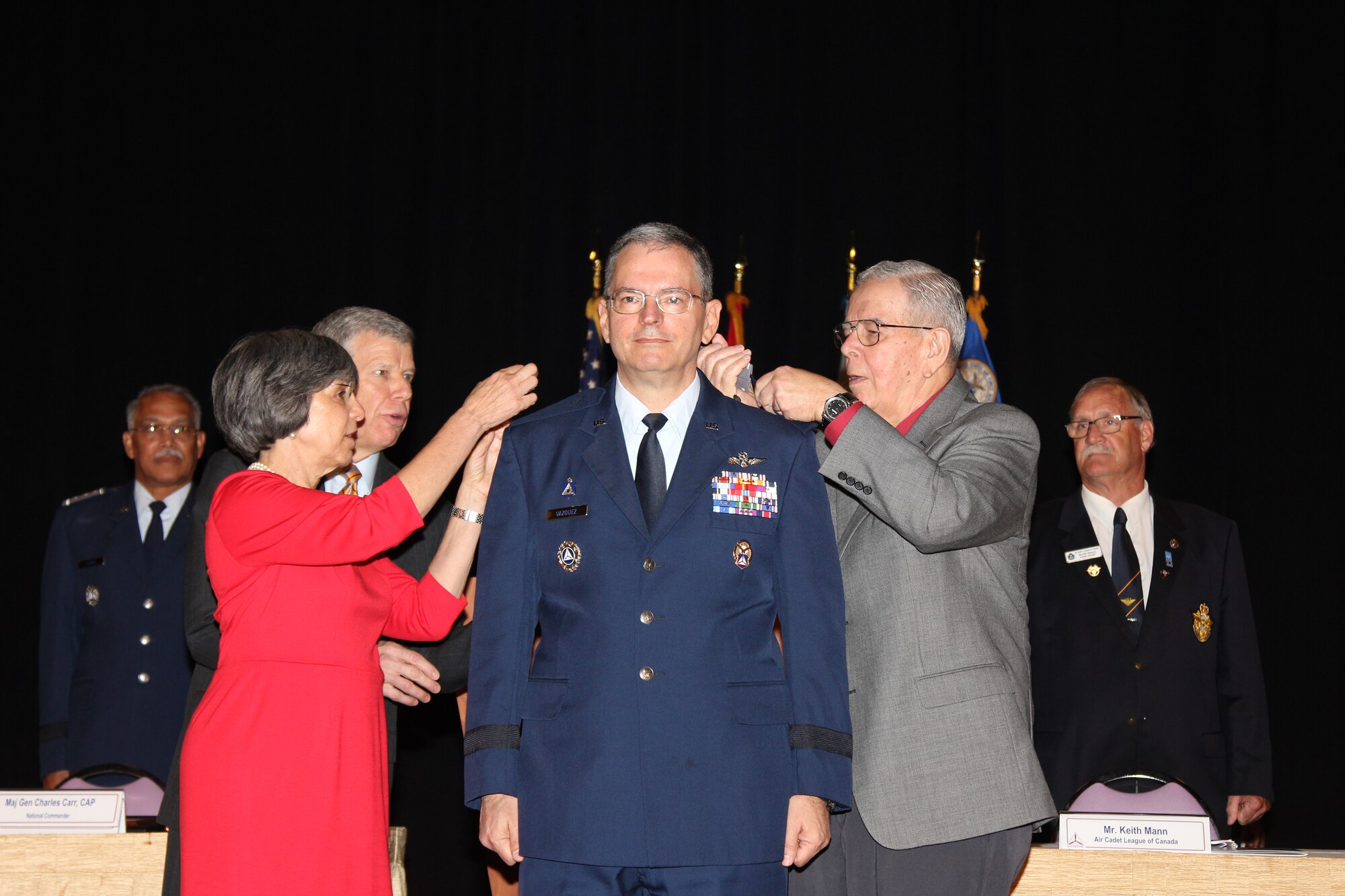 Maj. Gen. Joseph Vazquez, newly-appointed Civil Air Patrol National Commander, gets his new rank pinned by his wife, Lt. Col. Leslie Vazquez and his father, Jose Vazquez. As the commander, Vazquez will lead CAP’s 60,000 volunteers from around the nation who fulfill the organization’s  three congressionally-chartered missions of emergency services, cadet programs and aerospace education. (Photo by Susan Schneider/CAP National Headquarters)