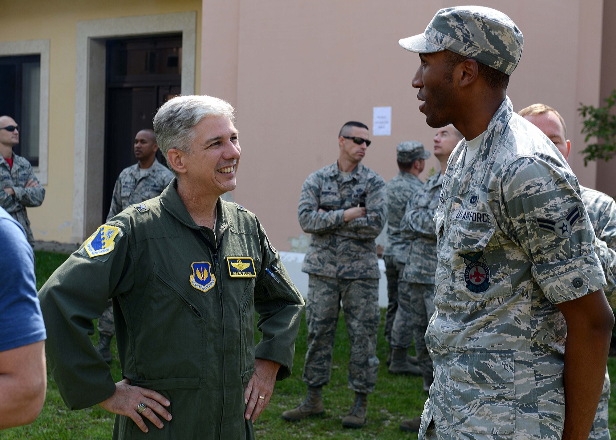 Brig. Gen. Barre Sequin, 31st Fighter Wing commander, talks to Airman 1st Class Paul Satterwhite, 31st Civil Engineer Squadron firefighter, during a dorm barbeque, Aug. 22, 2014, at Aviano Air Base, Italy. The event hosted basketball and volleyball games, corn-hole, and food throughout the afternoon. (U.S. Air Force photo/Tech. Sgt. Eric Donner) 