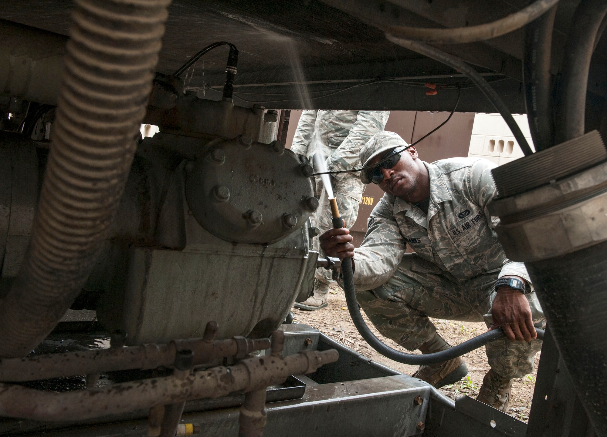 Senior Airman Dominique Eubanks, 51st Civil Engineer Squadron heating, ventilation, air condition and refrigeration journeyman, cleans a chiller at Osan AB, Republic of Korea, Aug. 15, 2014. A chiller is a machine that removes heat from a liquid through a vapor-compression or absorption refrigeration cycle. (U.S. Air Force photo by Senior Airman Matthew Lancaster)