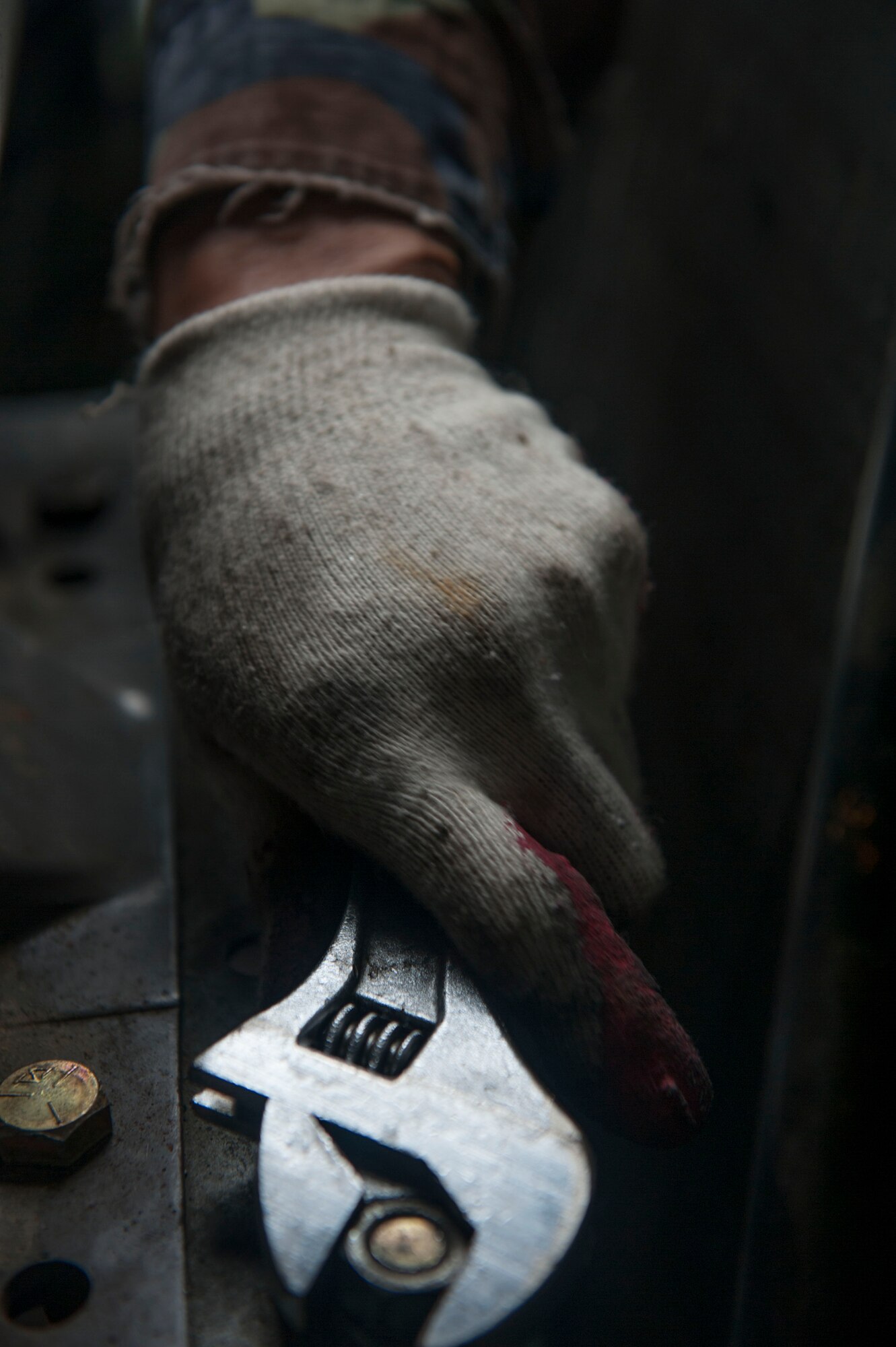 A Korean civilian attached to the 51st Civil Engineer Squadron heating, ventilation, air condition and refrigeration shop tightes a nut at Osan AB, Republic of Korea, Aug. 14, 2014. HVAC-R are responsible for installing, maintaining, repairing and operating furnaces, boilers, stoves, heat exchangers, burners, blowers, fans and radiant heaters. (U.S. Air Force photo by Senior Airman Matthew Lancaster)