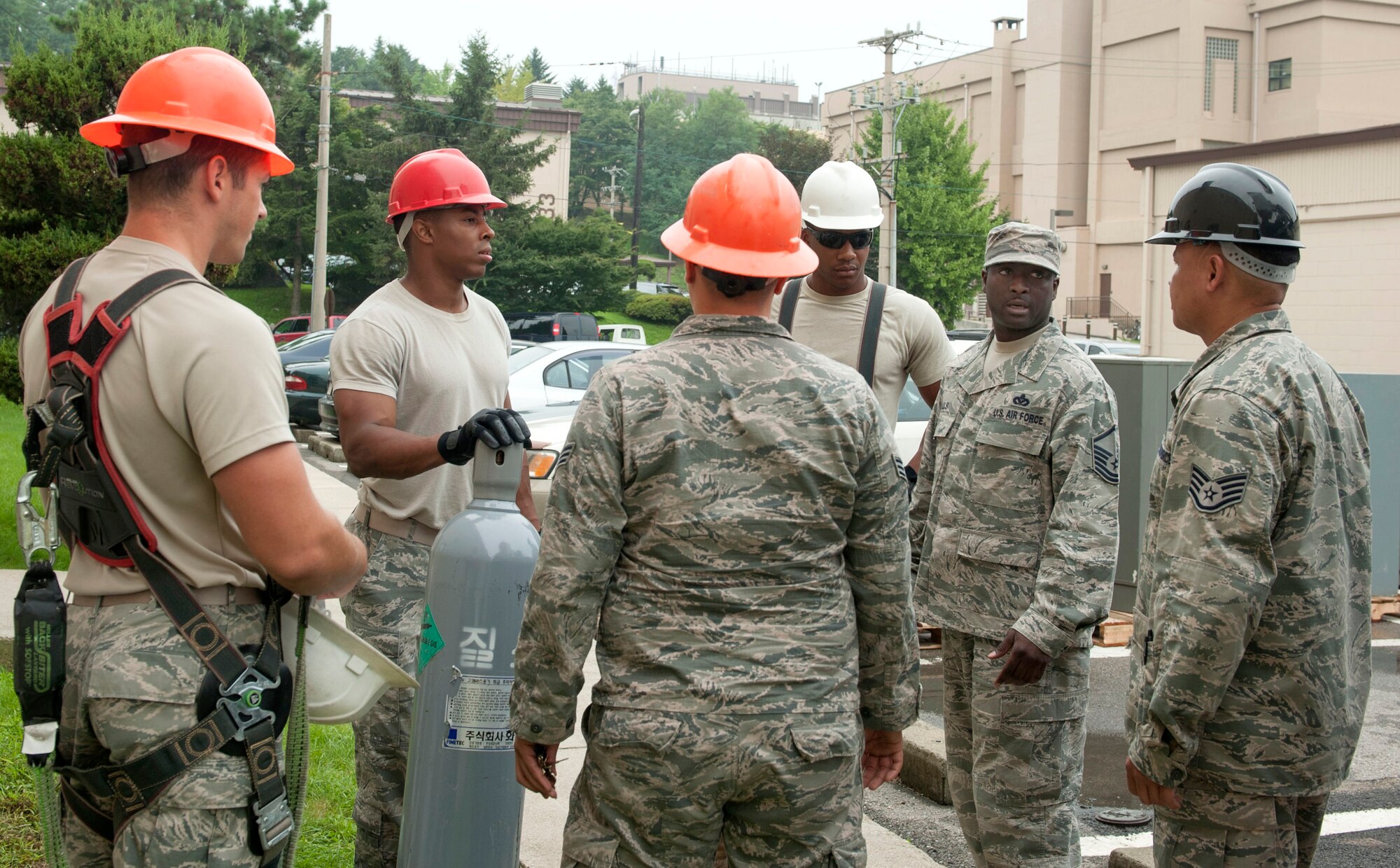 Members of the 51st Civil Engineer Squadron heating, ventilation, air condition and refrigeration shop have a group discussion before a job at Osan AB, Republic of Korea, Aug. 14, 2014. During these discussions, details about the task are clearified and properly assigned. (U.S. Air Force photo by Senior Airman Matthew Lancaster)