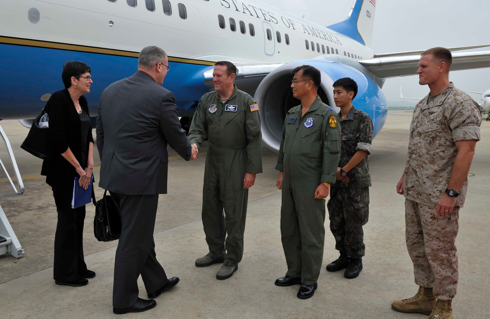 Deputy Secretary of Defense Bob Work is greeted by Maj. Gen. Robert Millmann Jr., 7th Air Force mobilization assistant to the commander, during his visit to Osan Air Base, Republic of Korea, Aug. 20, 2014. Work met with political leaders on the first day of his two-day visit. (U.S. Air Force photo/Senior Airman David Owsianka)
