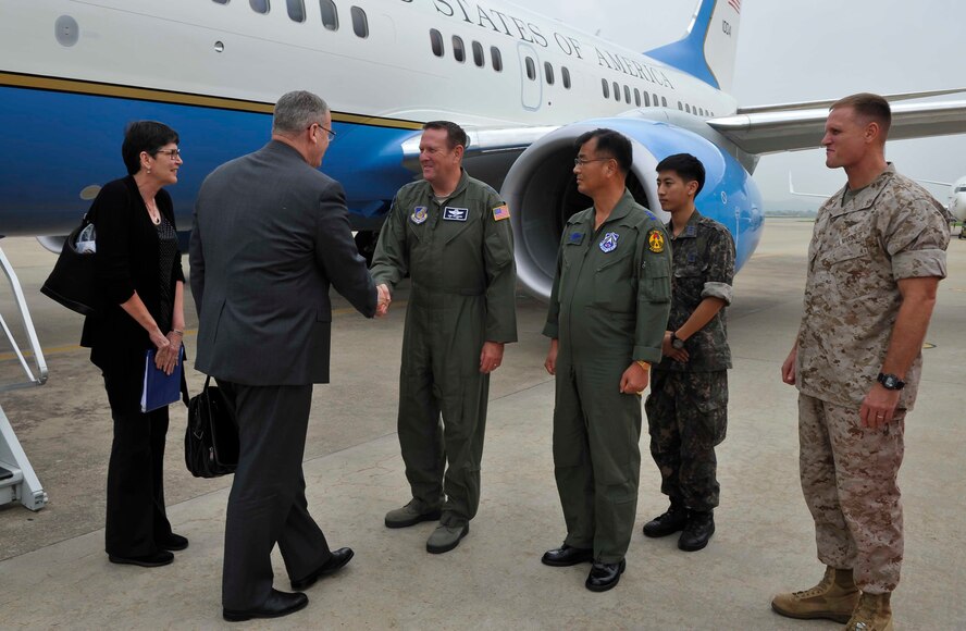 Deputy Secretary of Defense Bob Work is greeted by Maj. Gen. Robert Millmann Jr., 7th Air Force mobilization assistant to the commander, during his visit to Osan Air Base, Republic of Korea, Aug. 20, 2014. Work met with political leaders on the first day of his two-day visit. (U.S. Air Force photo by Senior Airman David Owsianka/Released) 