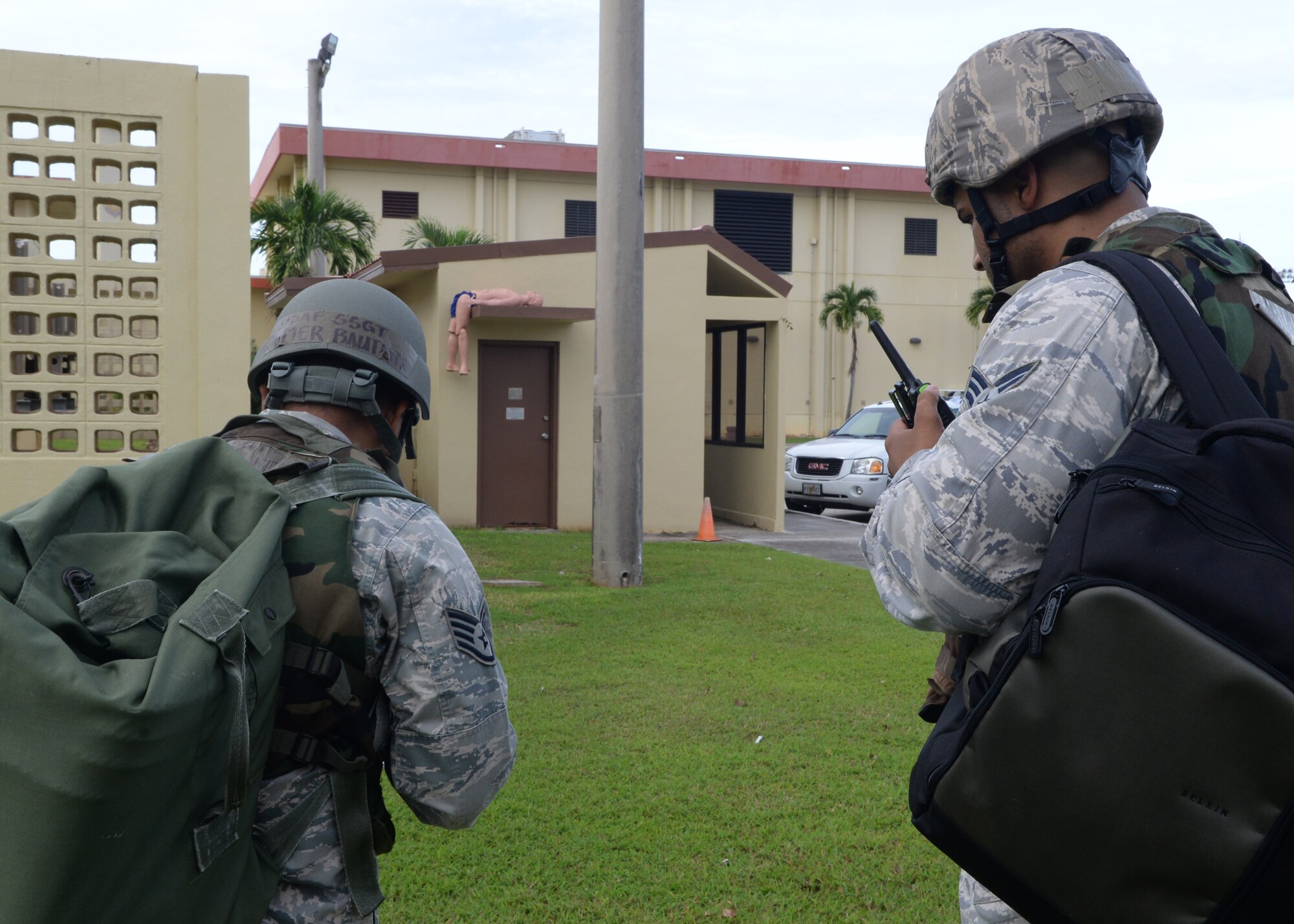 Staff Sgt. Jomer Bautista, 36th Comptroller Squadron customer service technician, and Senior Airman Tom Hammonds IV, 36th Contracting Squadron contract specialist, identify a simulated casualty while performing a post-attack reconnaissance sweep during Exercise Beverly Palm 14-04 Aug. 20, 2014, on Andersen Air Force Base, Guam. The 12-hour exercise took place to enhance the skills of Airmen in preparation for real-world contingencies. (U.S. Air Force photo by Airman 1st Class Amanda Morris/Released)