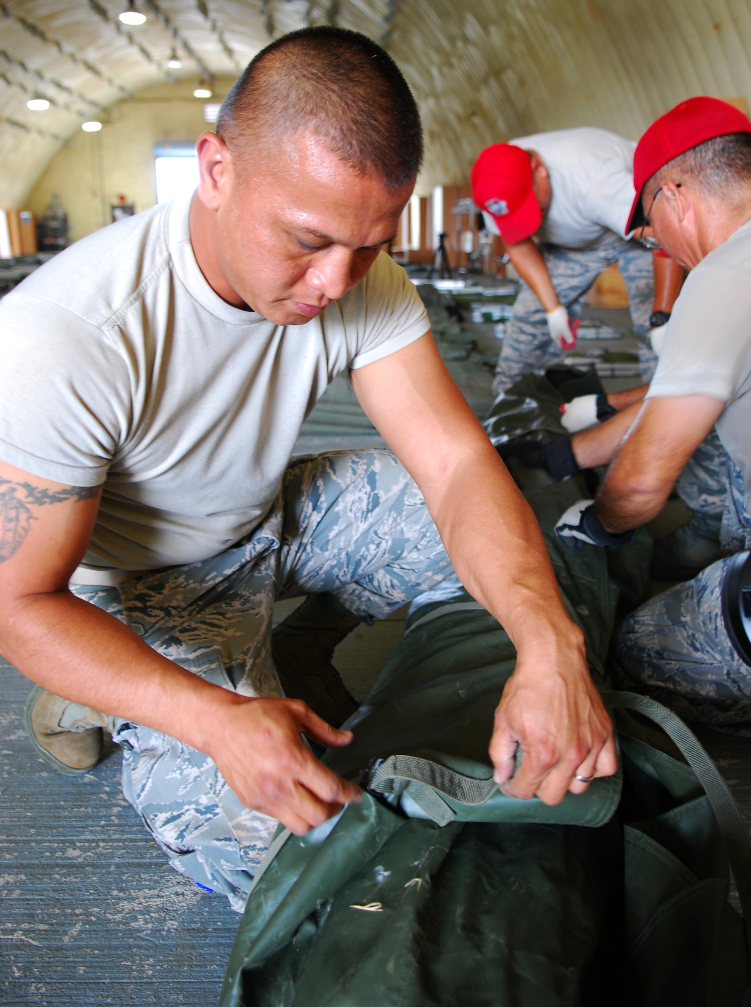 Staff Sgt. Joe Sablan, 254th RED HORSE electrical engineer, tightens the TEMPER tent straps at Rush Park, Osan Air Base, South Korea, during Ulchi Freedom Guardian, Aug. 18, 2014. Rush Park provided shelter for a portion of the 3,000 personnel from the U.S. and Pacific region that came to participate in UFG. (U.S. Air Force photo by Senior Airman Racheal E. Watson/Released)	