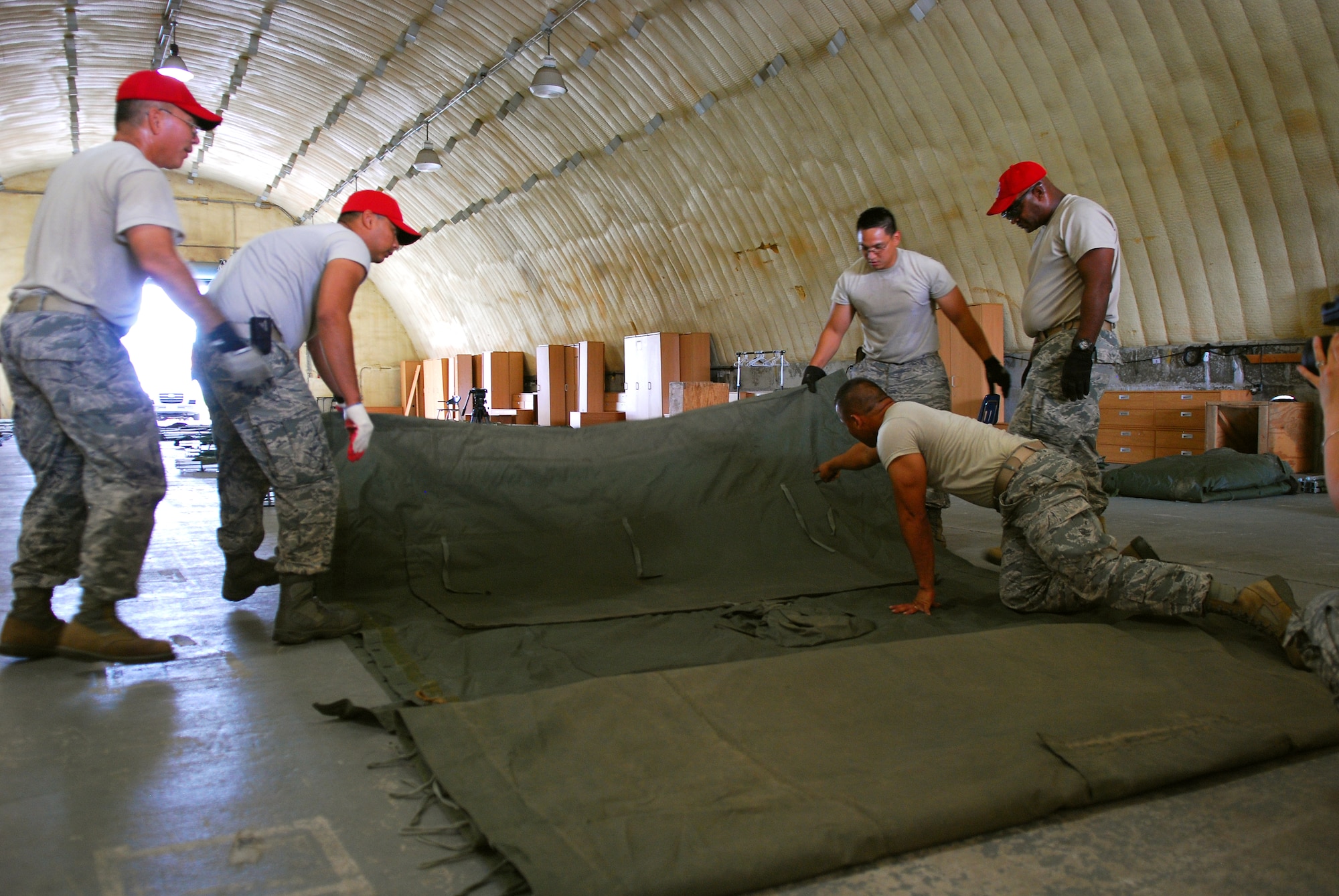 Members of 254th RED HORSE squadron fold TEMPER tents at Rush Park, Osan Air Base, South Korea, during Ulchi Freedom Guardian, Aug. 18, 2014. UFG is an exercise that takes place about the same time every year, to ensure the U.S./ROK Alliance is prepared to respond to threats across the spectrum of conflict. Some of the 254th RED HORSE staff were forward deployed to support the personnel playing a part in the two-week exercise. (U.S. Air Force photo by Senior Airman Racheal E. Watson/Released)