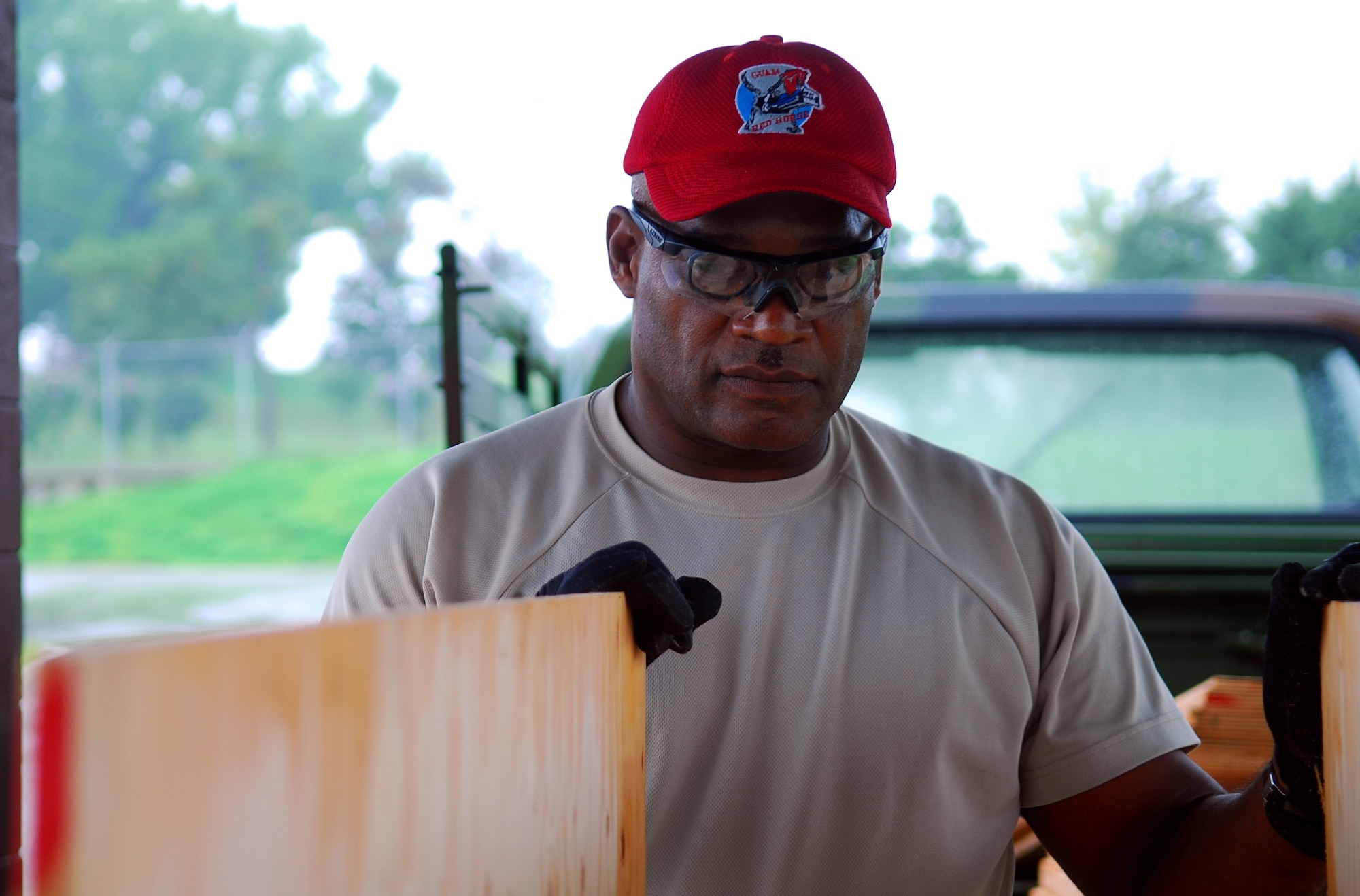 Master Sergeant Roberto Pitter, 254th RED HORSE squadron member, assesses the wood for an air conditioner deflector at Rush Park, Osan Air Base, South Korea, during Ulchi Freedom Guardian, Aug. 13, 2014. Pitter was one of 14 RED HORSE members who provided civil engineer support to the temporary housing for exercise augmentees. (U.S. Air Force photo by Senior Airman Racheal E.  Watson/Released)	