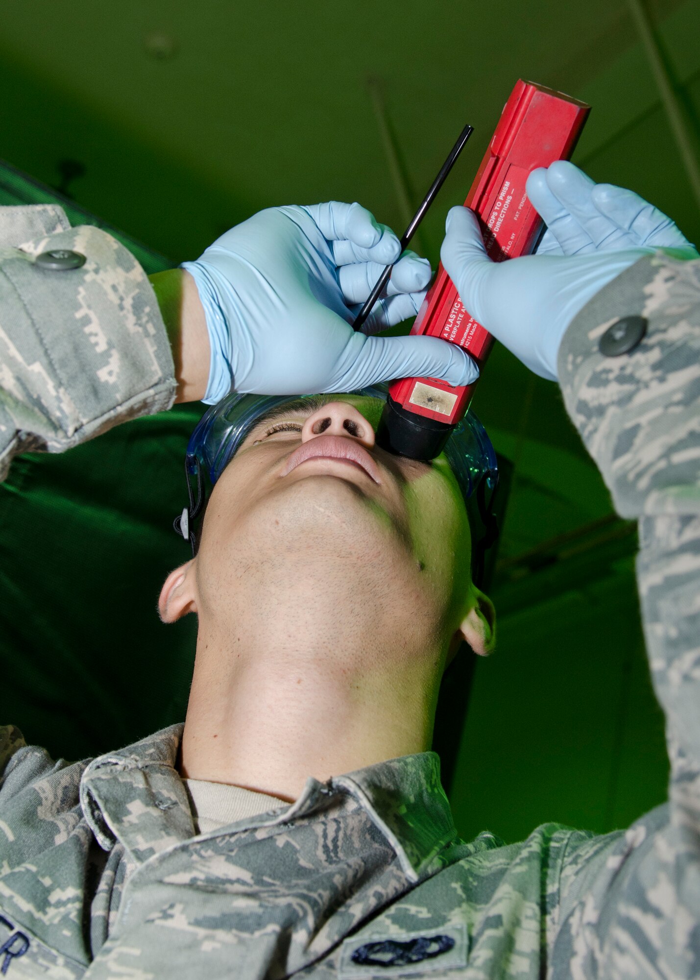 Airman 1st Class Ashton Surber, 36th Maintenance Squadron non-destructive inspection journeyman, inspects a sample of emulsifier during a routine quality control review  Aug. 21, 2014, on Andersen Air Force Base, Guam. NDI Airmen use this chemical in the penetrant process to remove excess, nonwater-washable penetrants from an aircraft part surface.  (U.S. Air Force photo by Senior Airman Katrina M. Brisbin/Released)