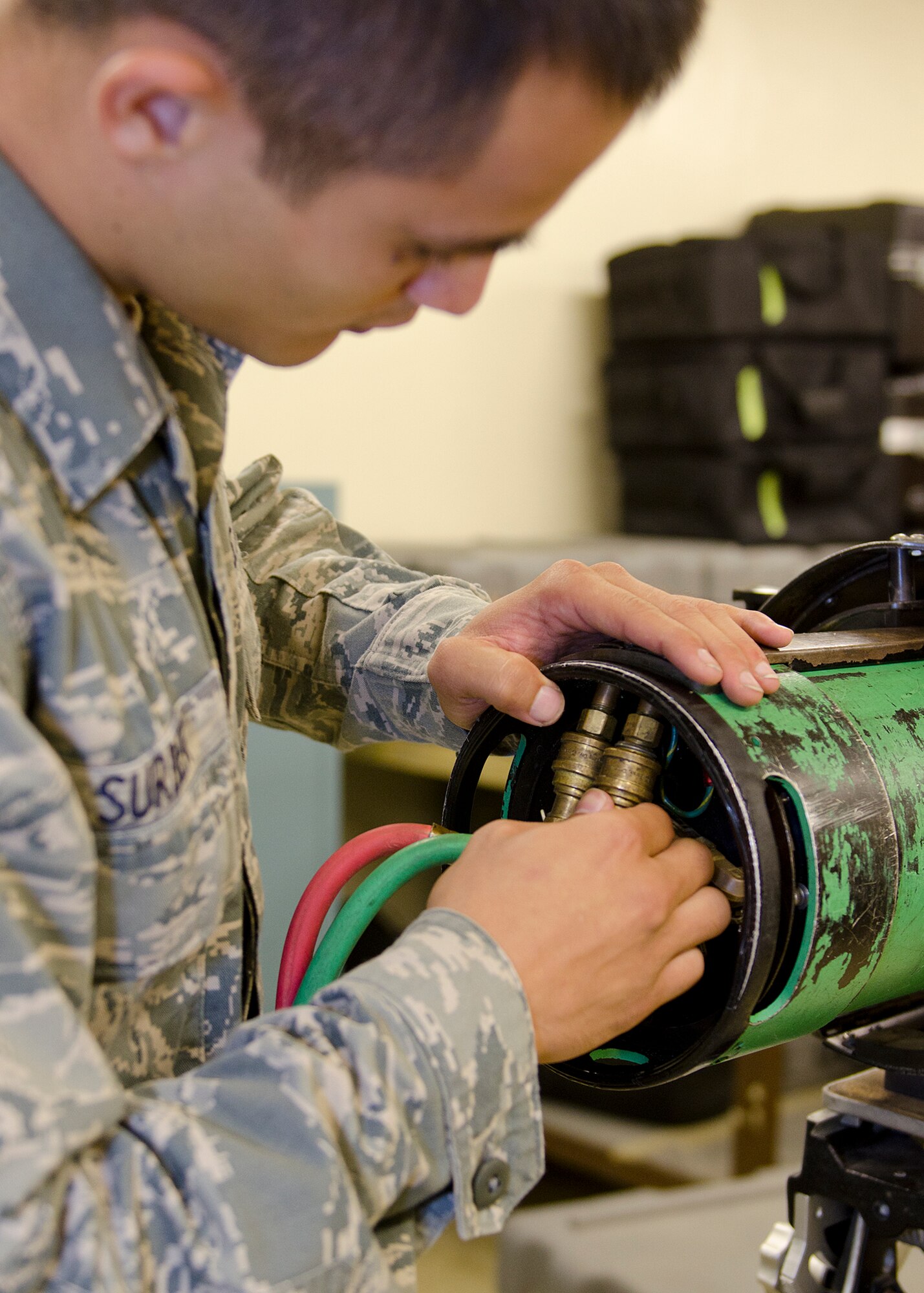 Airman 1st Class Ashton Surber, 36th Maintenance Squadron non-destructive inspection journeyman, adjusts a radiographic machine Aug. 21, 2014, on Andersen Air Force Base, Guam. NDI Airmen detect flaws using penetrant, magnetic particle, radiographic, optical and ultrasonic test equipment. (U.S. Air Force photo by Senior Airman Katrina M. Brisbin/Released)