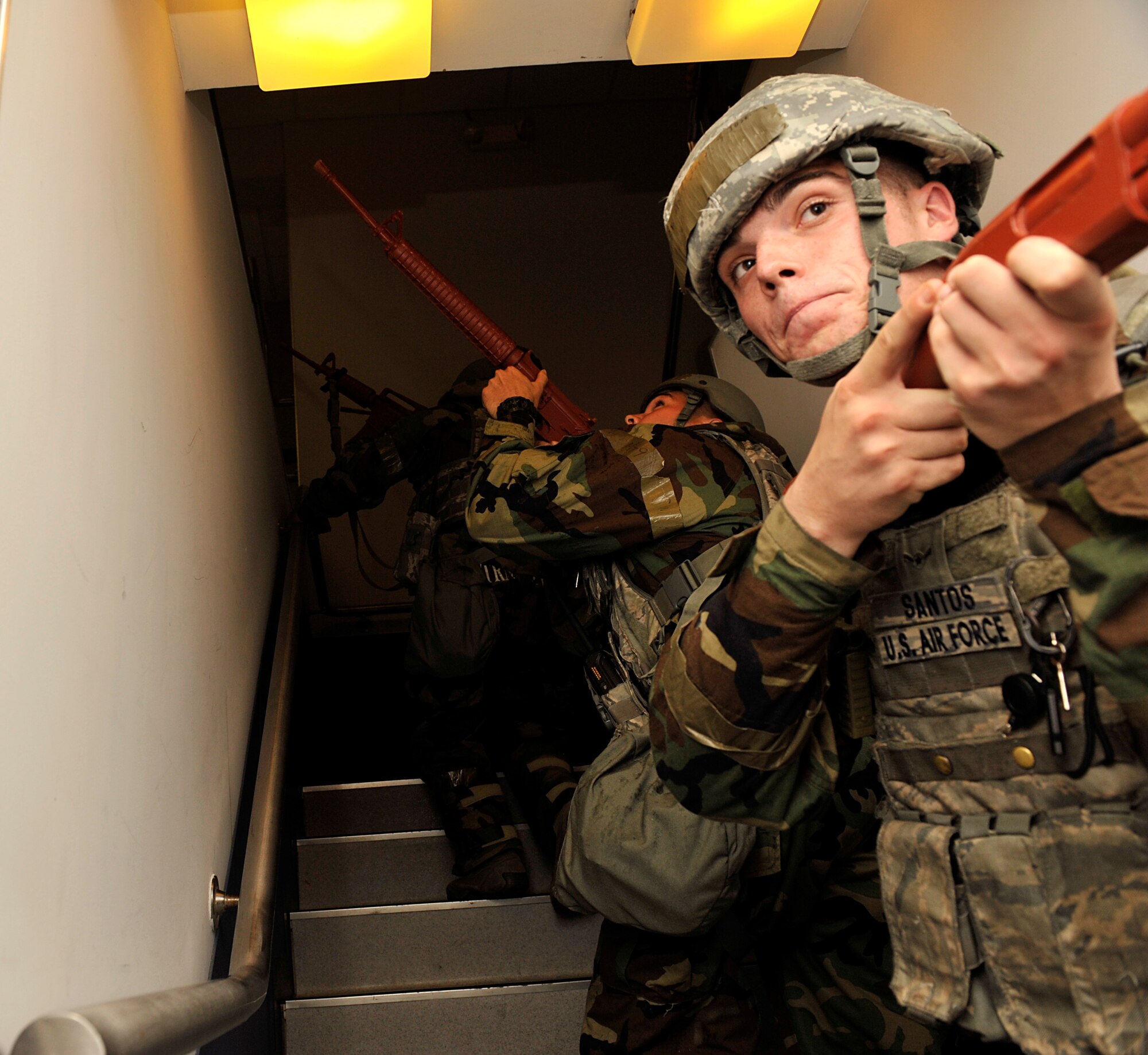 Members of the 18th Security Forces Squadron check the 733rd Air Mobility Squadron Passenger Terminal a during mission focused exercise on Kadena Air Base, Japan, Aug. 21, 2014. Members of the 18th SFS responded to an inject where opposing forces broke onto base and tried to take over at the AMS Passenger Terminal. (U.S. Air Force photo by Naoto Anazawa/Released)