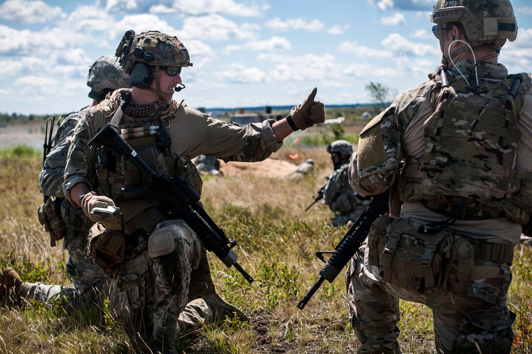Air Force Staff Sgt. Clark Collins gives a thumbs up on a request for close air support during Operation Northern Strike 2014 near Grayling, Mich., Aug. 13, 2014. Collins is a joint terminal air controllers assigned to the 118th Air Support Operations Squadron.
