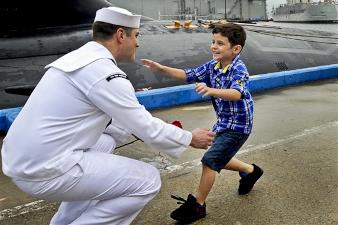 Navy Petty Officer 2nd Class Robert Culbertson greets his son after a six-month deployment on the attack submarine USS New Hampshire, which returned to its homeport on Naval Submarine Base New London in Groton, Conn., Aug. 13, 2014. 