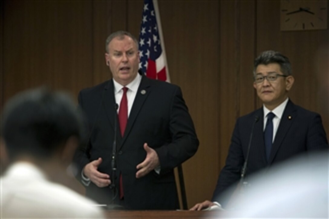 U.S. Deputy Defense Secretary Bob Work, left, and Japanese Senior Vice Defense Minister Ryota Takeda answer questions about U.S. and Japanese partnerships and ways to strengthen the Asia-Pacific region during a press conference in Tokyo, Aug. 22, 2014.