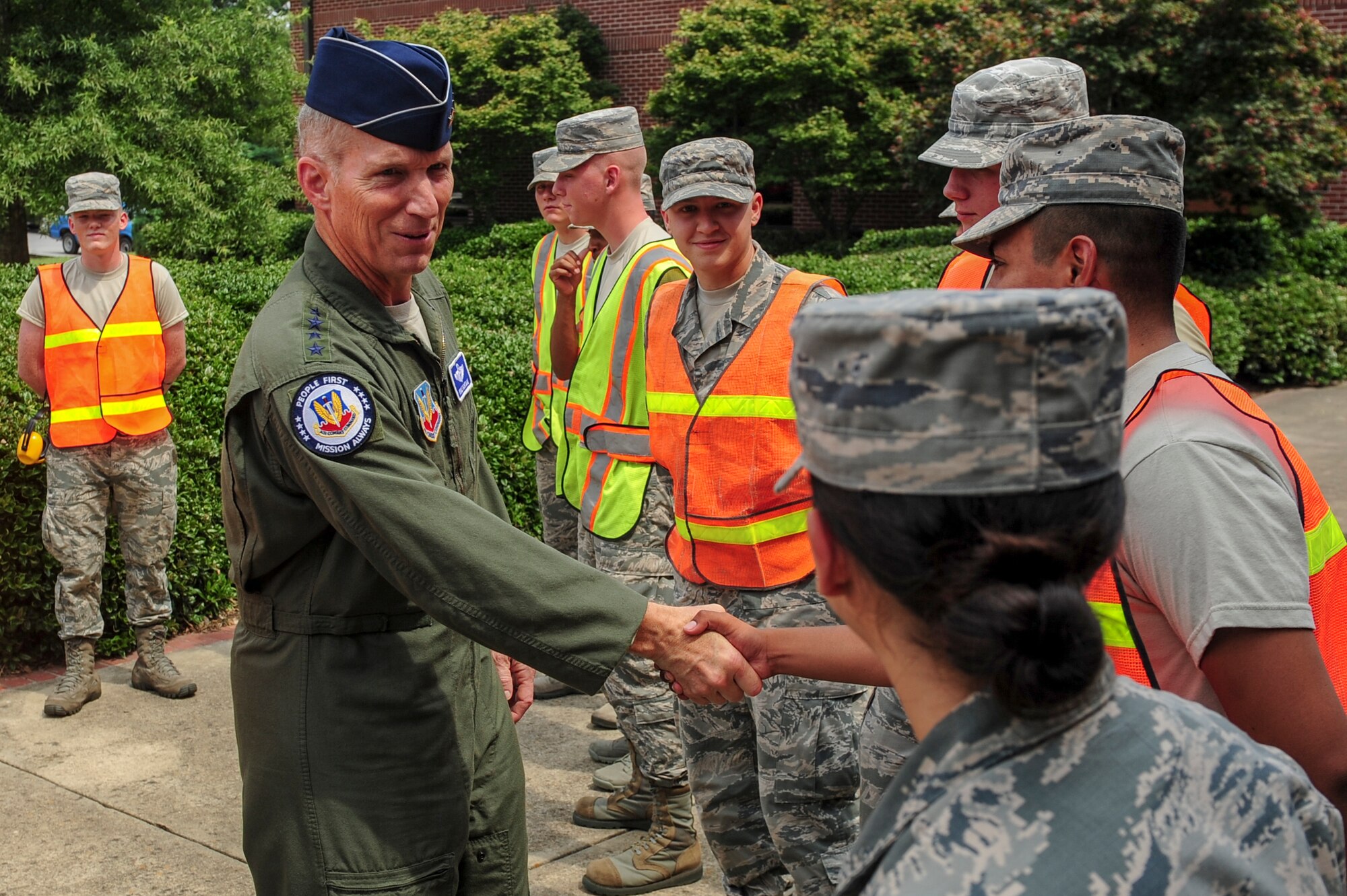 U.S. Air Force Gen. Mike Hostage, commander of Air Combat Command, greets 4th Fighter Wing Pride Team members during an orientation tour at Seymour Johnson Air Force Base, North Carolina, Aug. 21. The Pride Team is a group of Airmen who help uphold the installation’s appearance.  (U.S. Air Force photo by Airman 1st Class Brittain Crolley/Released)