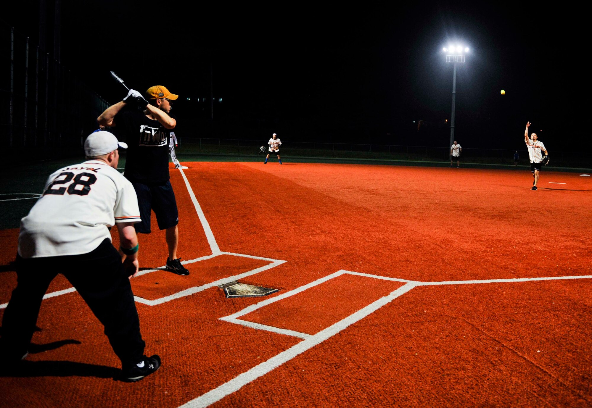Marc Flores, 51st Operations Support Squadron, pitches to Chris Brassard, 51st Security Forces Squadron, during the fourth inning of the intramural softball championship game on Osan Air Base, Republic of Korea, Aug. 21, 2014. The 51st SFS team built a 14-6 lead after the fourth inning. (U.S. Air Force photo/Senior Airman David Owsianka)