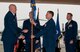 JOINT BASE ELMENDORF-RICHARDSON, Alaska -- Col. Darrin Slaten takes  command of the 176th Operations Group at a change-of-command ceremony here Aug. 23, 2014, as former commander Col. Blake Gettys (at right) moves to higher headquarters. National Guard photo by Staff Sgt. N. Alicia Halla/Released