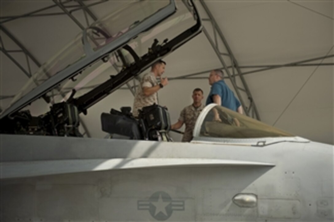 U.S. Deputy Defense Secretary Bob Work gets a tour of a U.S. Marine Corps F/A-18D Hornet on Marine Corps Air Station Iwakuni, Japan, Aug. 23, 2014, during his visit to the Asia-Pacific region. The Hornet is assigned to the All Weather Fighter Attack Squadron 242.