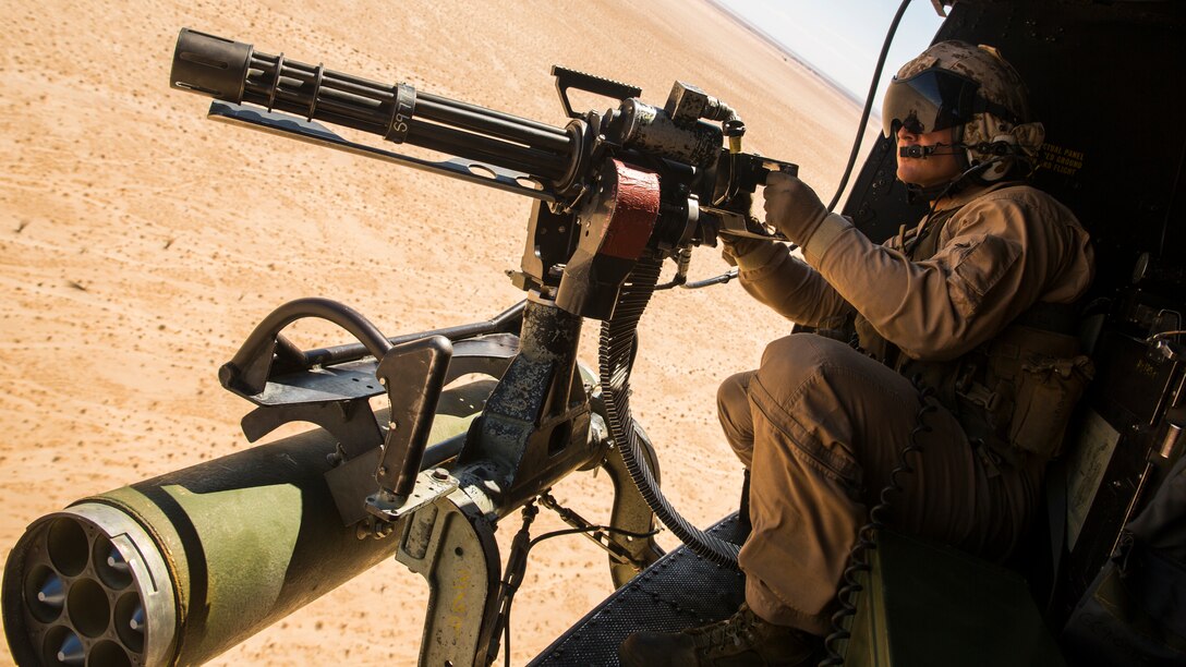 Lance Cpl. Christopher Eliff, a crew chief with Marine Light Helicopter Squadron 369, based at Marine Corps Base Camp Pendleton, Calif., and a Houston native, mounts a GAU-11 Minigun during a moving target exercise at the Yodaville Urban Target Complex, located in the Barry M. Goldwater Range, Ariz., Wednesday, Aug. 20, 2014. The crew chiefs expended more than 6,000 rounds during the exercise, building proficiency in their gunnery skillsets.