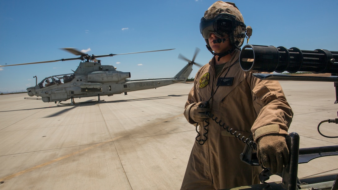 Lance Cpl. Christopher Eliff, a crew chief with Marine Light Helicopter Squadron 369, based at Marine Corps Base Camp Pendleton, Calif., and a Houston native, awaits a flight aboard the flight line of Marine Corps Air Station Yuma, Ariz., Wednesday, Aug. 20, 2014. HMLA-369 relocated to MCAS Yuma from Aug. 17-22, expending thousands of rounds of ammunition and flying approximately 150 hours during their visit to provide their Marines with intense training.