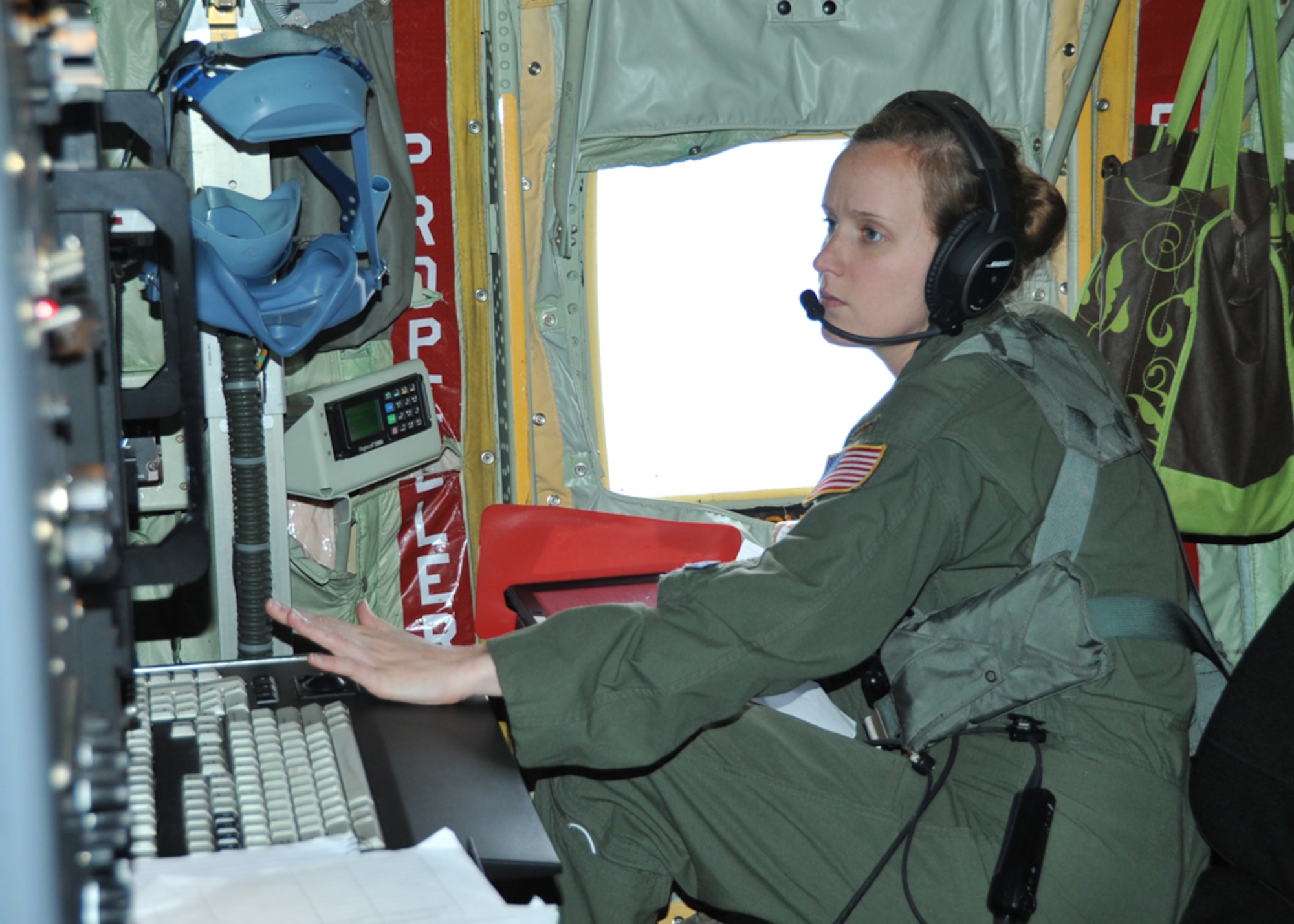 2nd Lt. Leesa Froelich, 53rd Weather Reconnaissance Squadron aerial reconnaissance weather officer, analyzes meteorological and atmospheric conditions during a 96L, now Tropical Storm Cristobal, invest mission over the Caribbean Aug. 22, 2014. The data the Hurricane Hunters collect is sent by satellite link to the National Hurricane Center in Miami to assist with their weather forecasts. (U.S. Air Force photo/Maj. Marnee A.C. Losurdo)