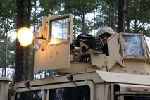 A Marine with Transportation Support Company, Combat Logistics Battalion 6, 2nd Marine Logistics Group fires blank ammunition from a M-240B machine gun while fending off a mock ambush during a field exercise aboard Marine Corps Base Camp Lejeune, N.C., Aug. 20, 2014. The exercise helps the company maintain mission readiness for future deployments.