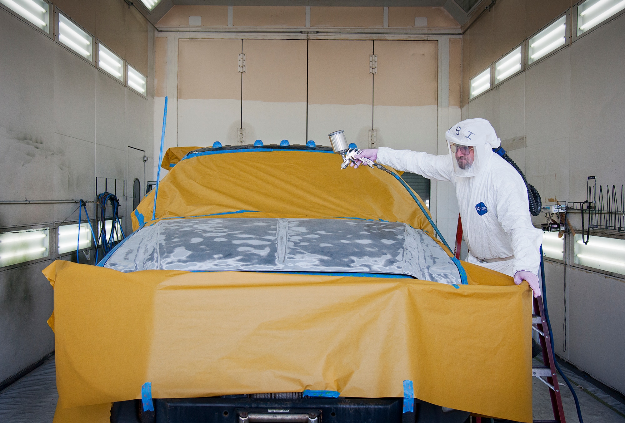 Henry Isaacs  prepares to paint the hood of a truck Aug. 20,2014, at Eglin Air Force Base, Fla. Repainting vehicle parts affected by the sun and weather is part of 96th Logistics Readiness Squadron’s corrosion control program. A three-person team is responsible for restoring and extending the lives of Eglin AFB’s vehicle fleet. Approximately 50 vehicles per year are painted by the team. Isaacs is assigned to the 96th LRS. (U.S. Air Force photo/Samuel King Jr.)