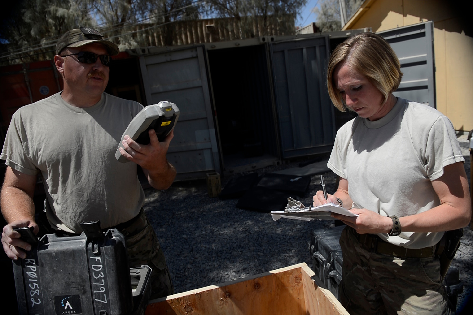 Master Sgt. Phillip Hauser (left) and Tech Sgt. Stacy Trosine inventory equipment at Kandahar Airfield, Afghanistan Aug. 18, 2014.  Hauser and Trosine are EOD logistics management non-commissioned officers-in-charge with 466th Operating Location Bravo. Since 2004, there have been 20 rotations of more than 600 EOD technicians who have left their mark in the history of Operation Enduring Freedom.   (U.S. Air Force photo/Staff Sgt. Evelyn Chavez)