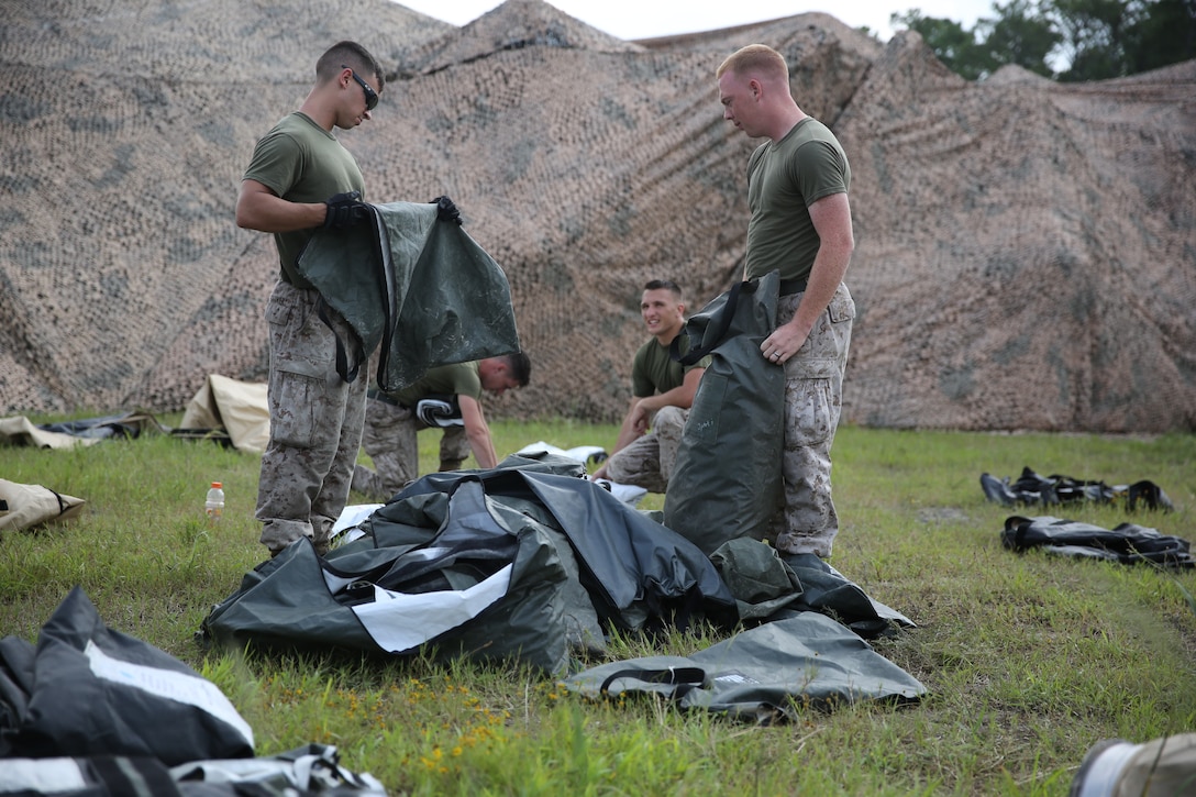 Marines with Marine Tactical Air Command Squadron 28 organize equipment for a tactical air command center at Marine Corps Air Station Cherry Point, N.C., Aug. 21, 2014. The squadron constructed the TACC to develop its expeditionary capabilities and deployment readiness. 