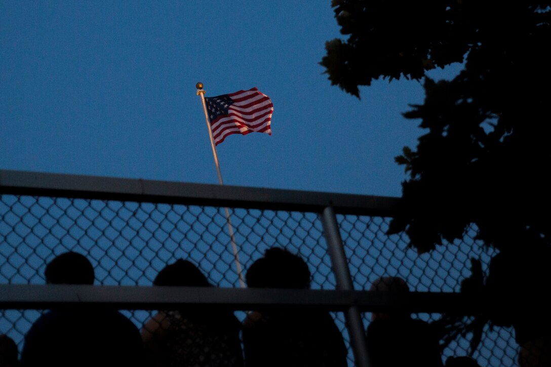 An altered version of the American flag flies over Marine Barracks Washington at 8th & I, prior to the start of a Friday Evening Parade, Aug. 22, 2014. The flag has 15 stars and 15 stripes to represent the 15 states that existed in 1801. 