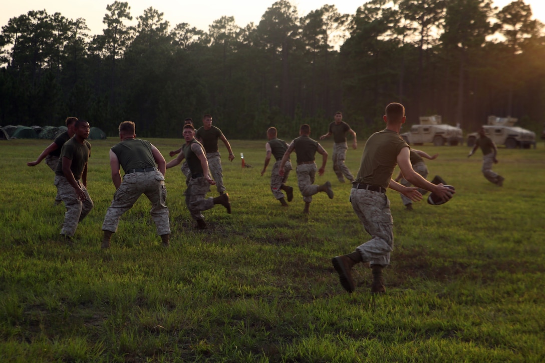 Marines with Transportation Support Company, Combat Logistics Battalion 6, 2nd Marine Logistics Group play football at the end of a field exercise aboard Marine Corps Base Camp Lejeune, North Carolina, Aug. 21, 2014. The Marines ended the nearly week-long exercise with a field meet and warriors’ night to solidify the camaraderie built by the company during the operation.