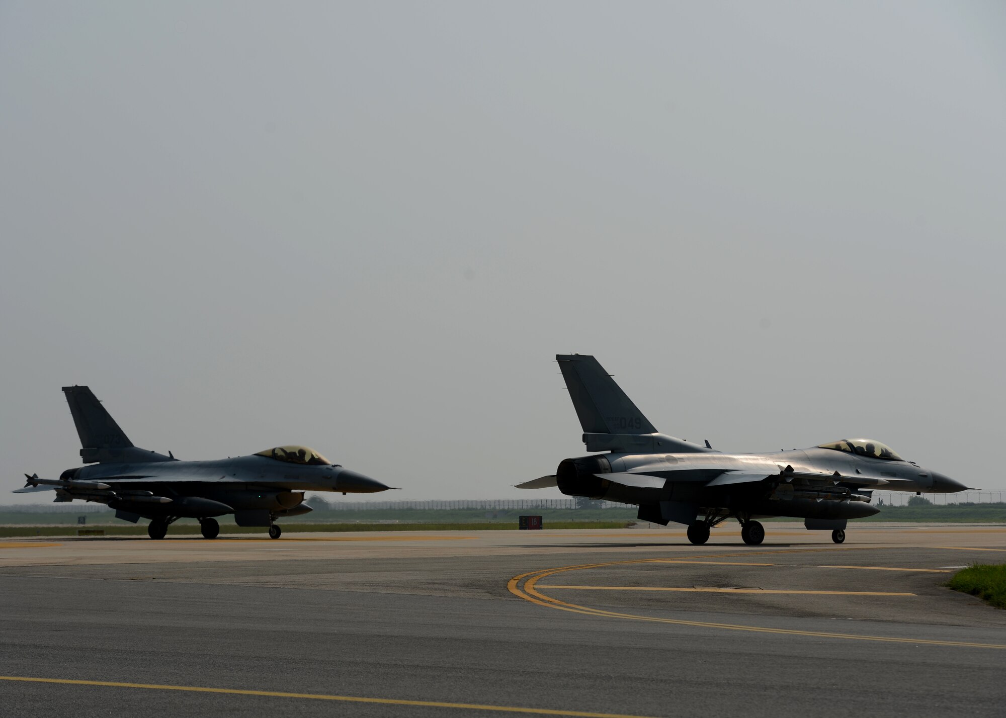 Republic of Korea Air Force F-16 Fighting Falcons from the 111th Fighter Squadron land at Kunsan Air Base, Republic of Korea, after a training mission Aug. 22, 2014. The ROKAF works with the 8th Operations Support Group to train, support and defend the region. (U.S. Air Force photo by Senior Airman Justyn M. Freeman/Released)