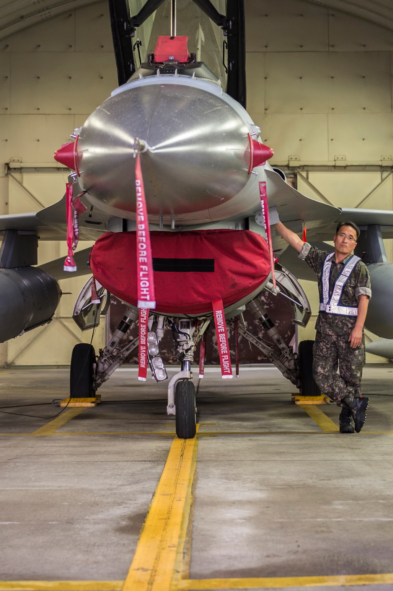 Republic of Korea Air Force F-16 Fighting Falcon maintainers from the 111th Fighter Squadron prepare the aircraft for a training mission at Kunsan Air Base, Republic of Korea, before a training mission Aug. 22, 2014. The ROKAF works with the 8th Operations Support Group to train and defend the region. (U.S. Air Force photo by Staff Sgt. Stephany Richards/ Released)