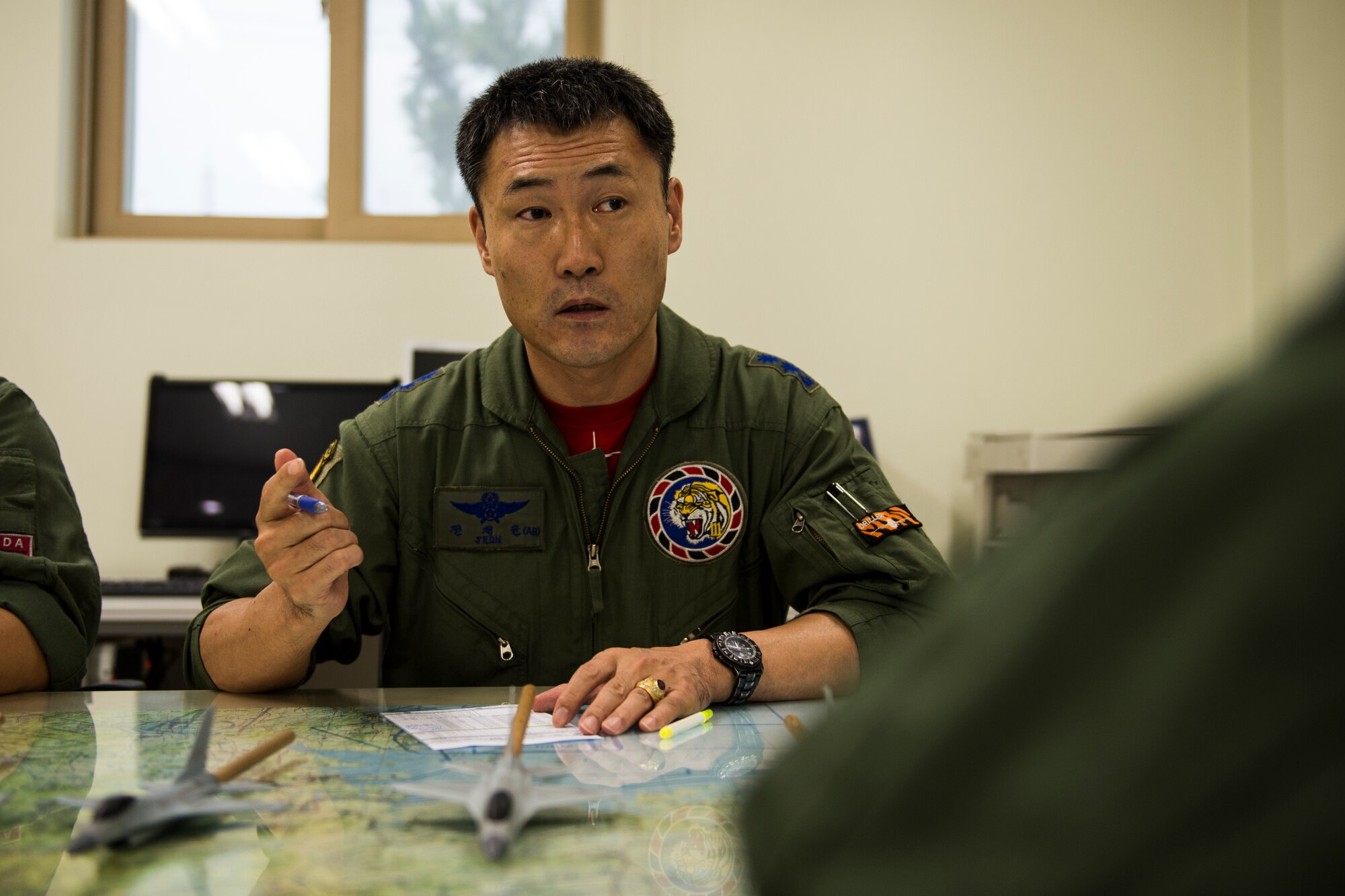 A Republic of Korea Air Force F-16 Fighting Falcon pilot from the 111th Fighter Squadron briefs flight plans at Kunsan Air Base, Republic of Korea, before a training mission Aug. 22, 2014. The ROKAF works with the 8th Operations Support Group to train and defend the region. (U.S. Air Force photo by Staff Sgt. Stephany Richards/ Released)