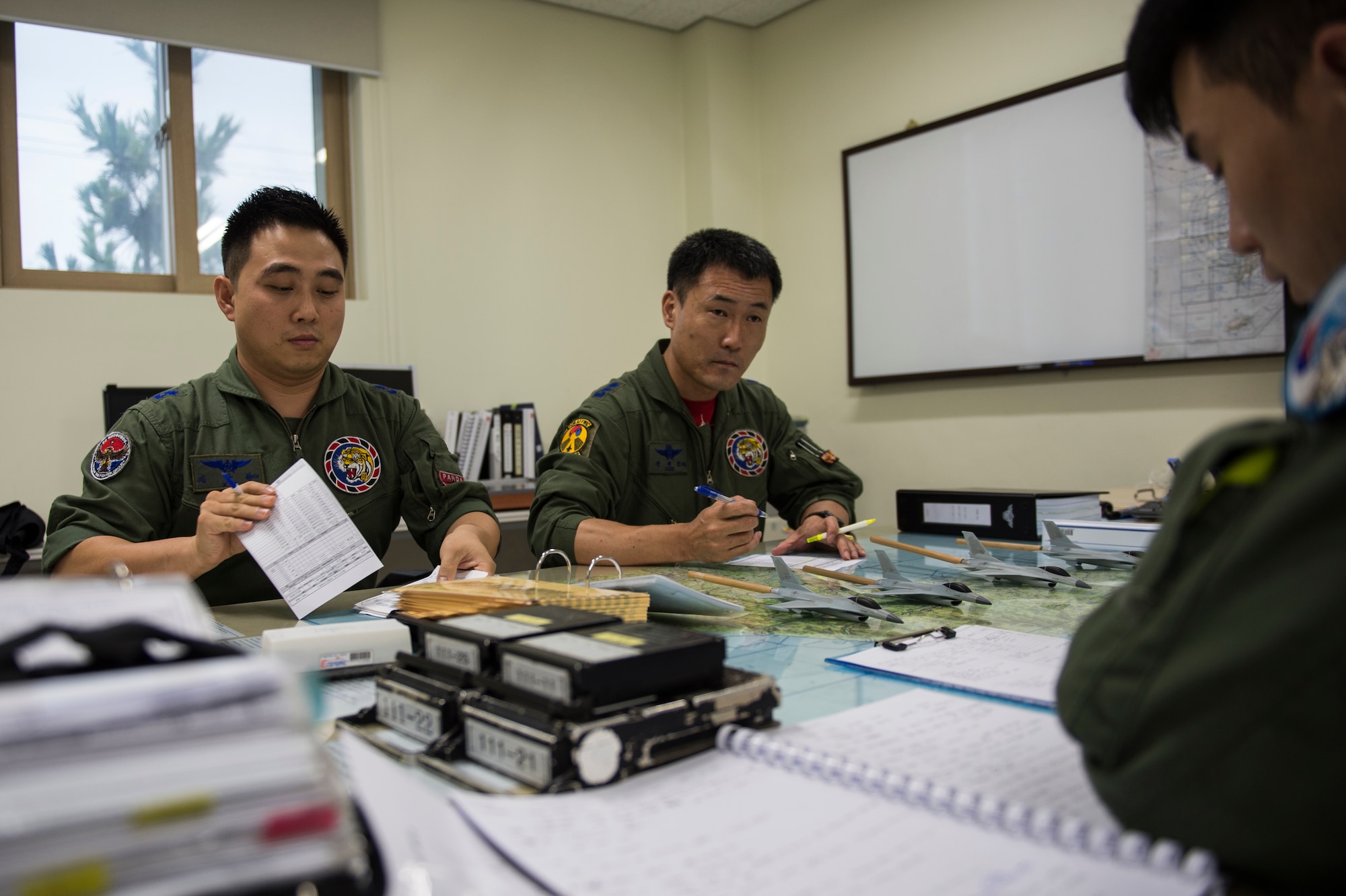 Republic of Korea Air Force F-16 Fighting Falcon pilots from the 111th Fighter Squadron brief flight plans at Kunsan Air Base, Republic of Korea, before a training mission Aug. 22, 2014. The ROKAF works with the 8th Operations Support Group to train and defend the region. (U.S. Air Force photo by Staff Sgt. Stephany Richards/ Released)