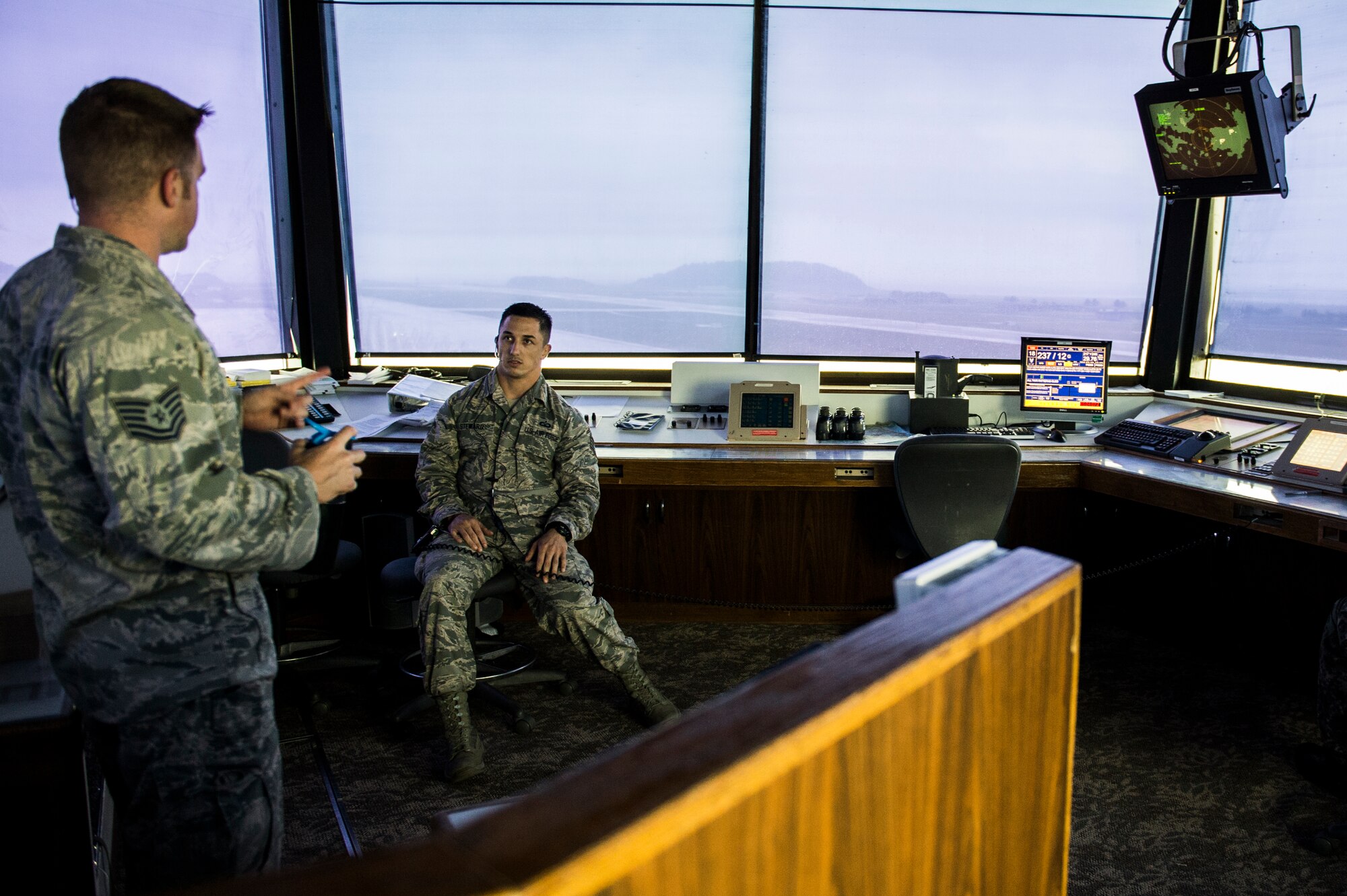 U.S. Air Force Tech. Sgt. Nick Day (left), 8th Operations Support Squadron aircraft tower control watch supervisor, talks with Staff Sgt. Kyle Steward, 8th OSS aircraft tower control watch supervisor, about aircraft approaching the airfield at Kunsan Air Base, Republic of Korea, Aug. 21, 2014. The 8th OSS is the backbone of the 8th Operations Group, providing the aircrews the support they need to keep on flying. (U.S. Air Force photo by Staff Sgt. Stephany Richards/ Released)